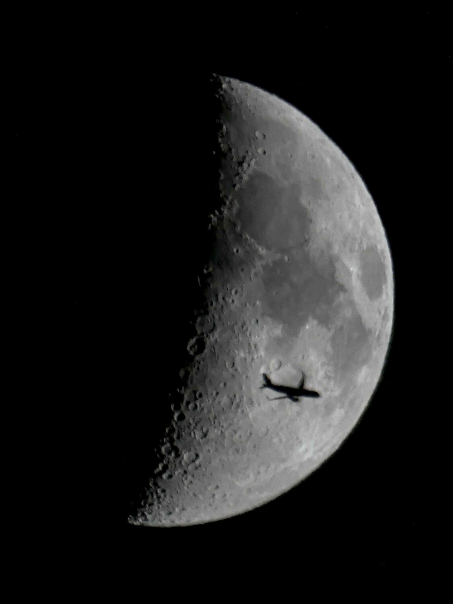 Plane crosses the moon