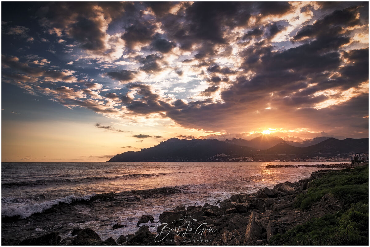 Sunset between sea and mountains