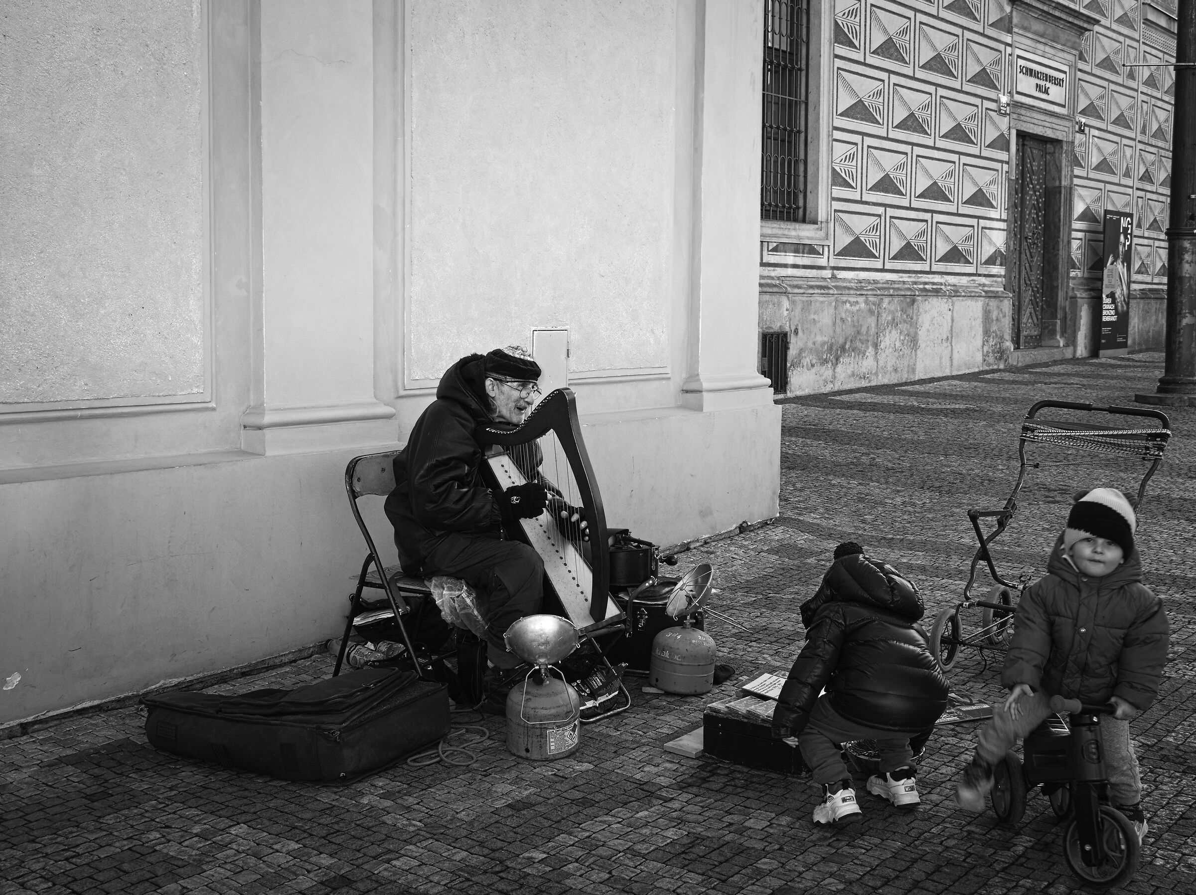 Senior street artist with festive children