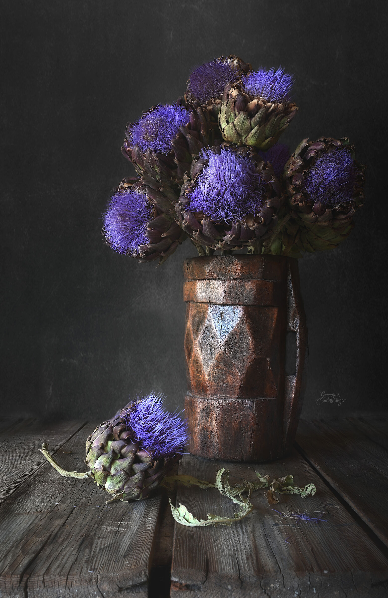 A wooden vase and artichoke flowers