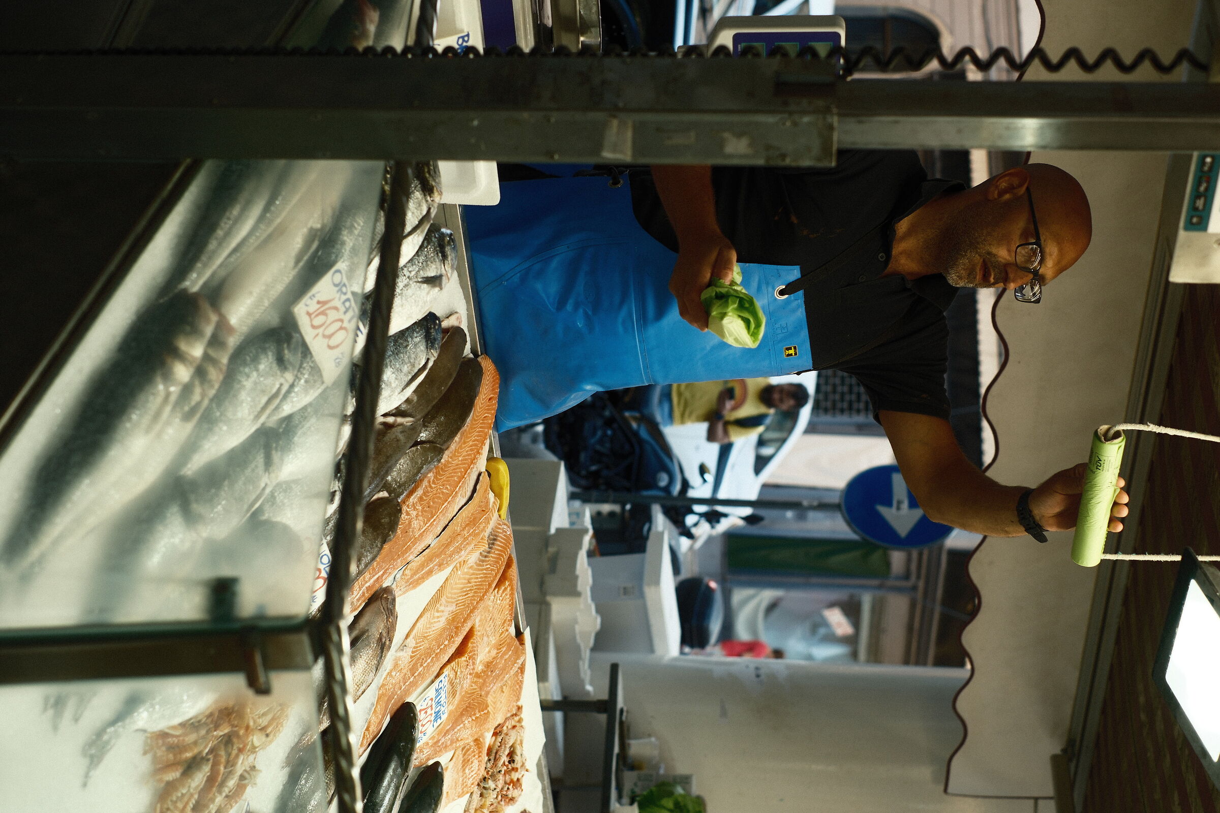 fishmonger takes bag
