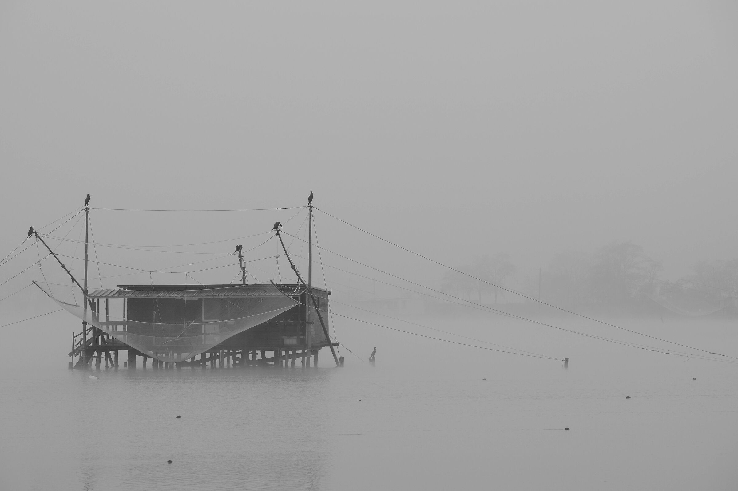 Fishing hut in the morning mists