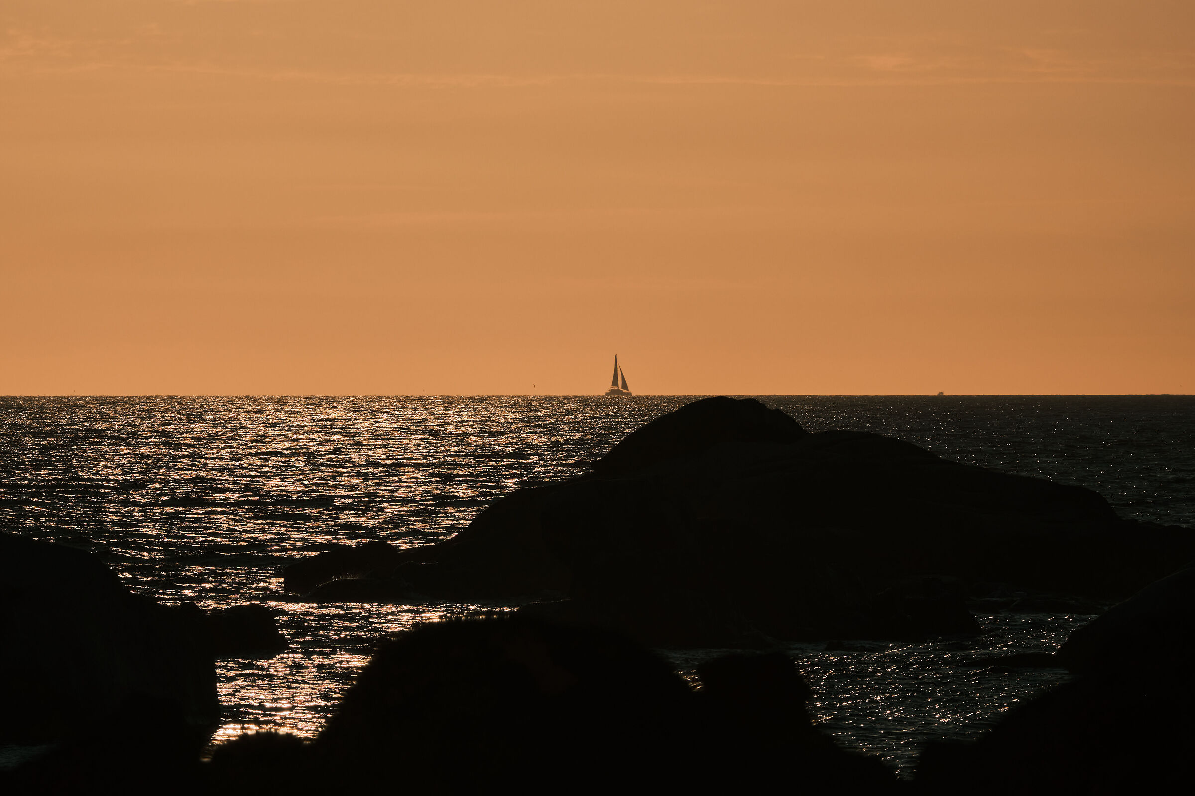 A small boat on the horizon