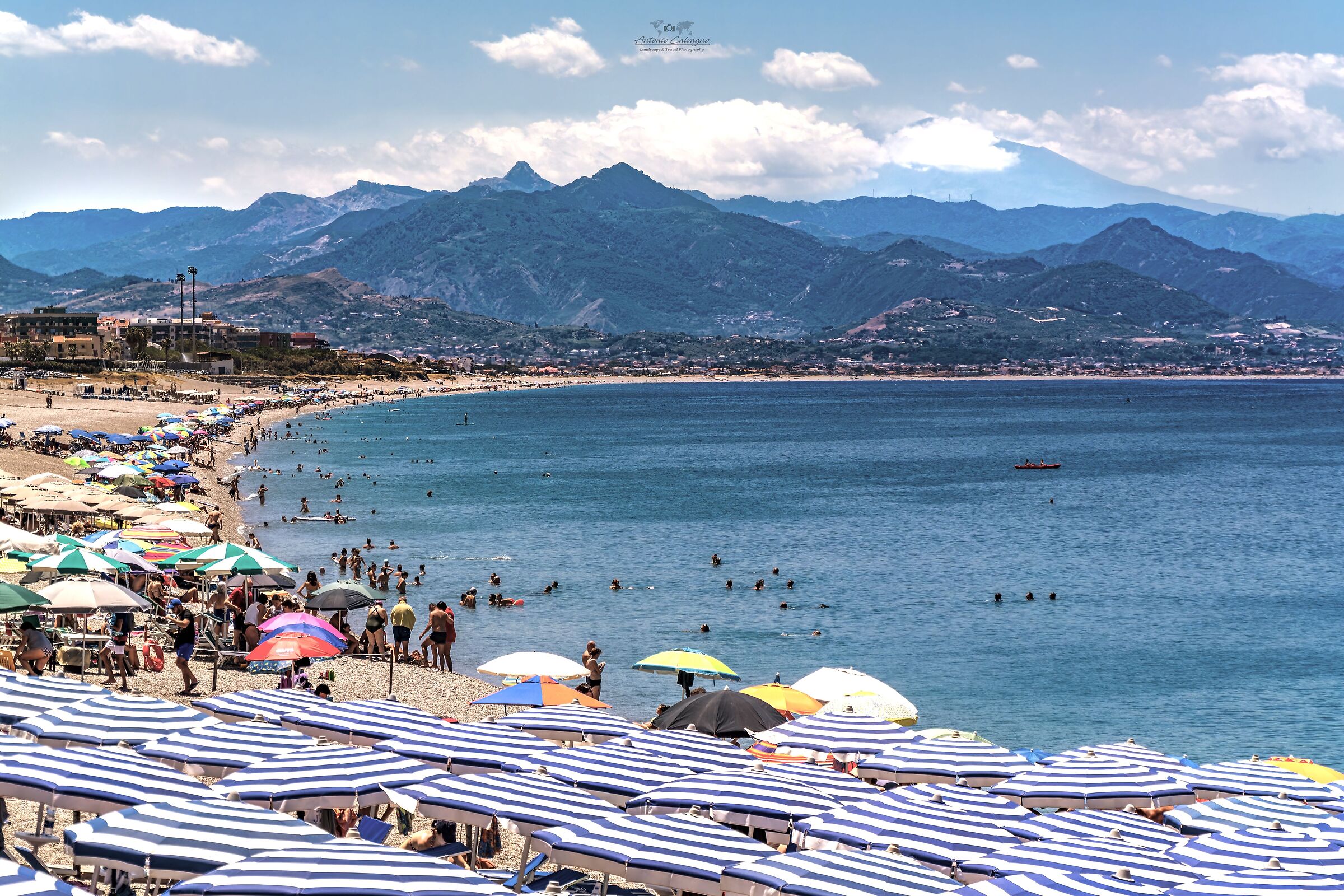 Baia del Tono and in the background you can see Mount Etna.