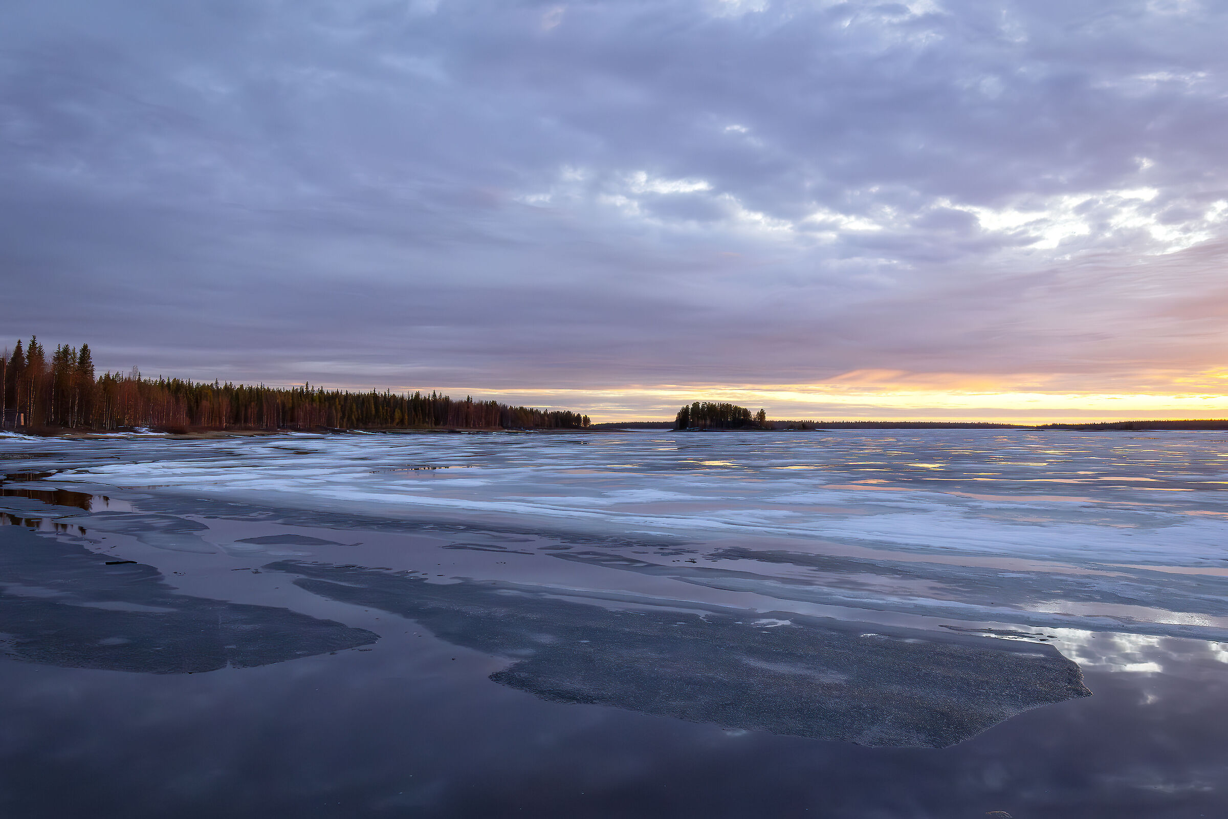 Sunset over frozen lake