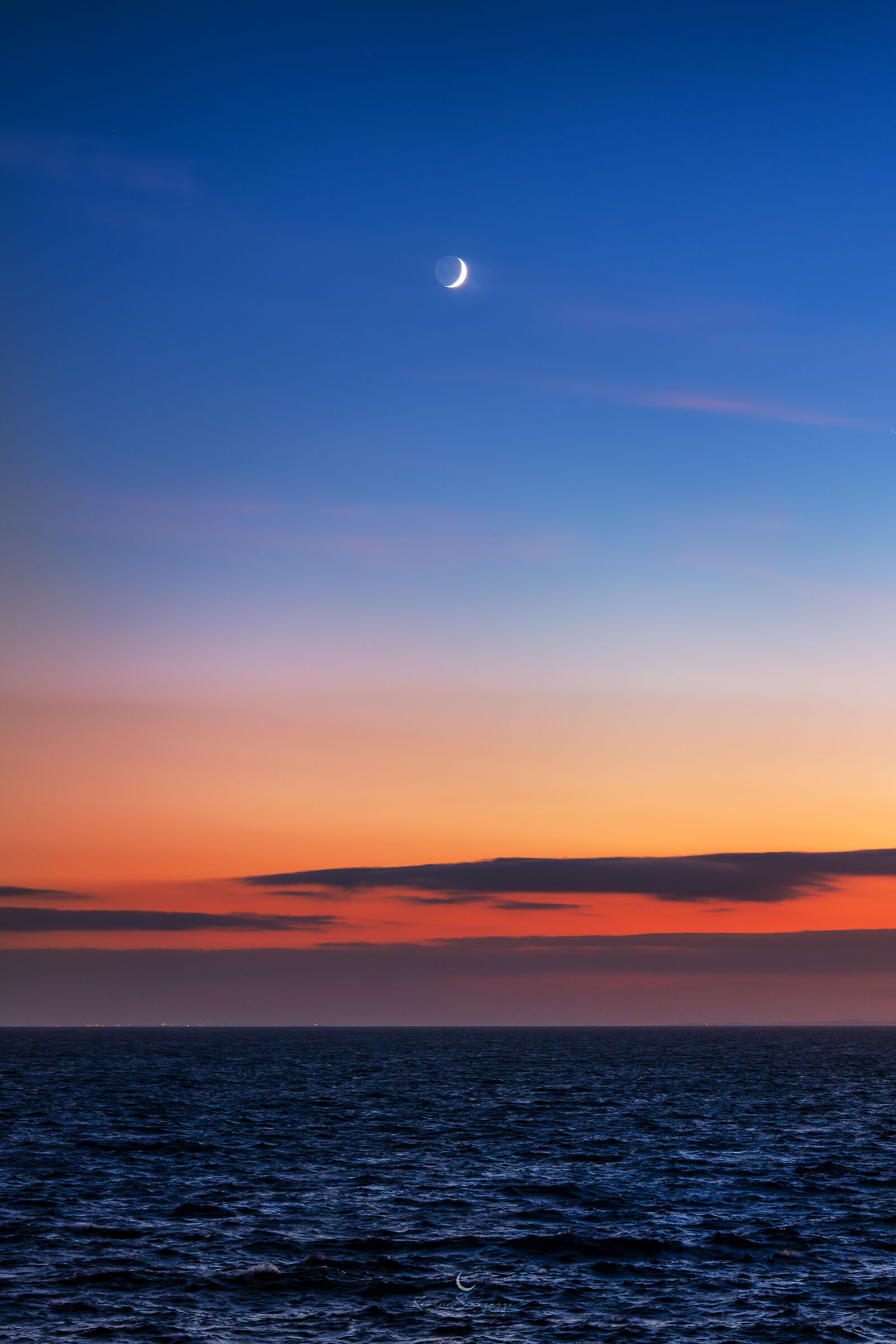 Sickle among the colors of the sunset