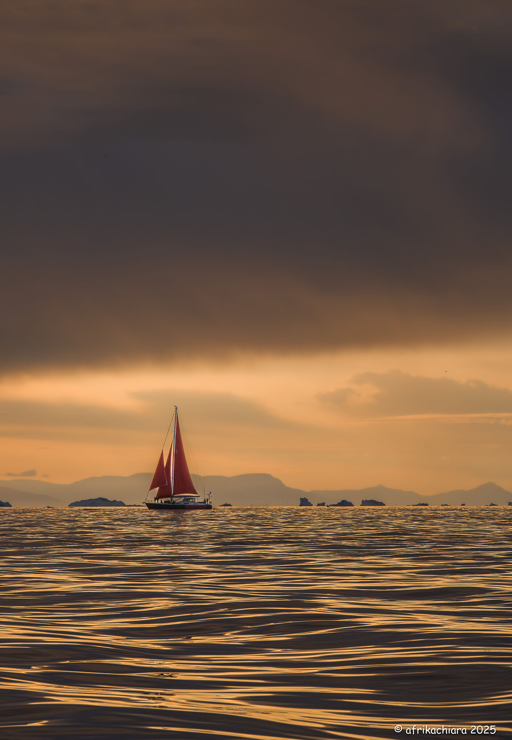 Red sails in the golden sea of the Arctic Circle