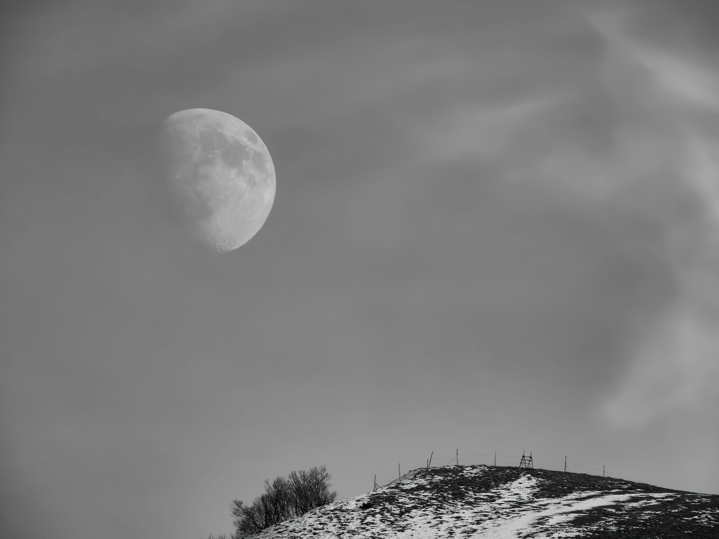 The moon rises from the mountain