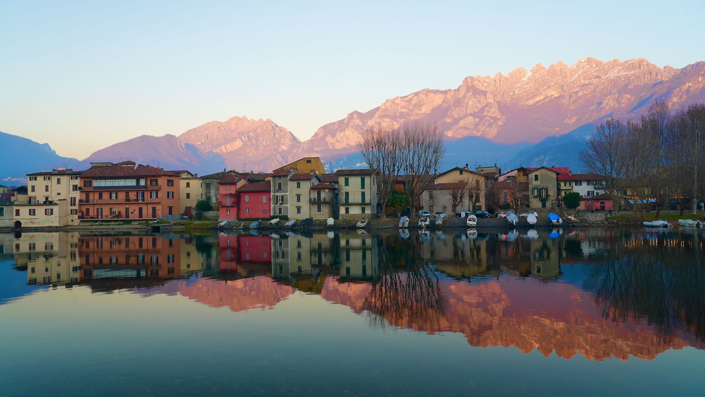 Pesacarenico is reflected in the river with the Resegone