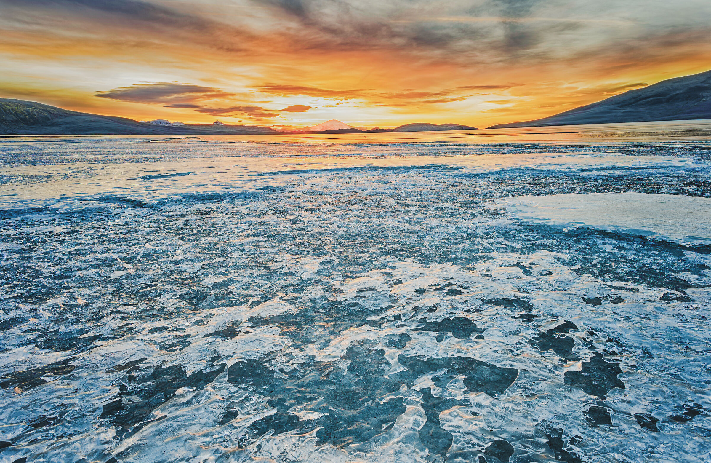 SUNSET OVER FROZEN LAKE