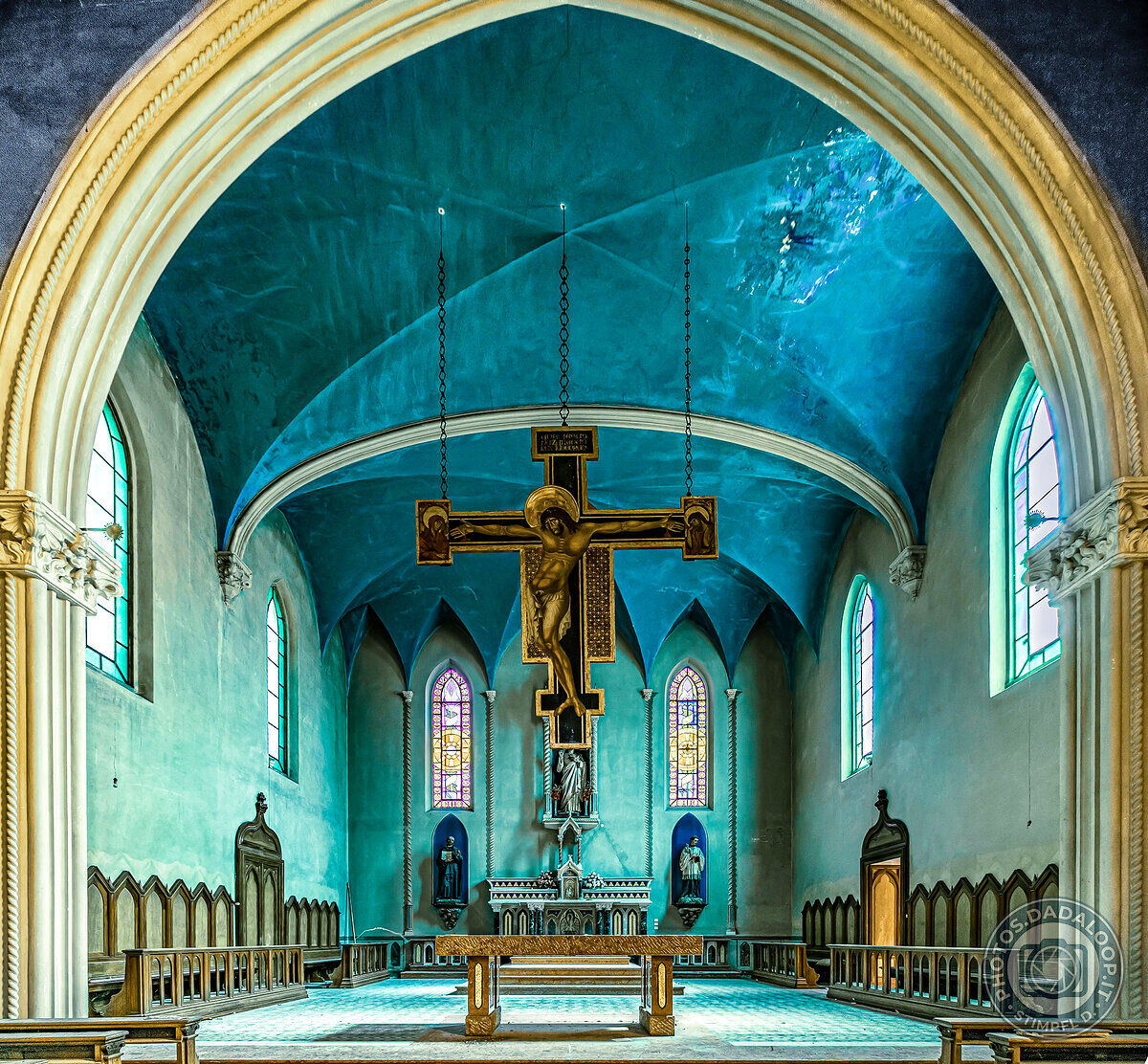 Abandoned church with golden crucifix
