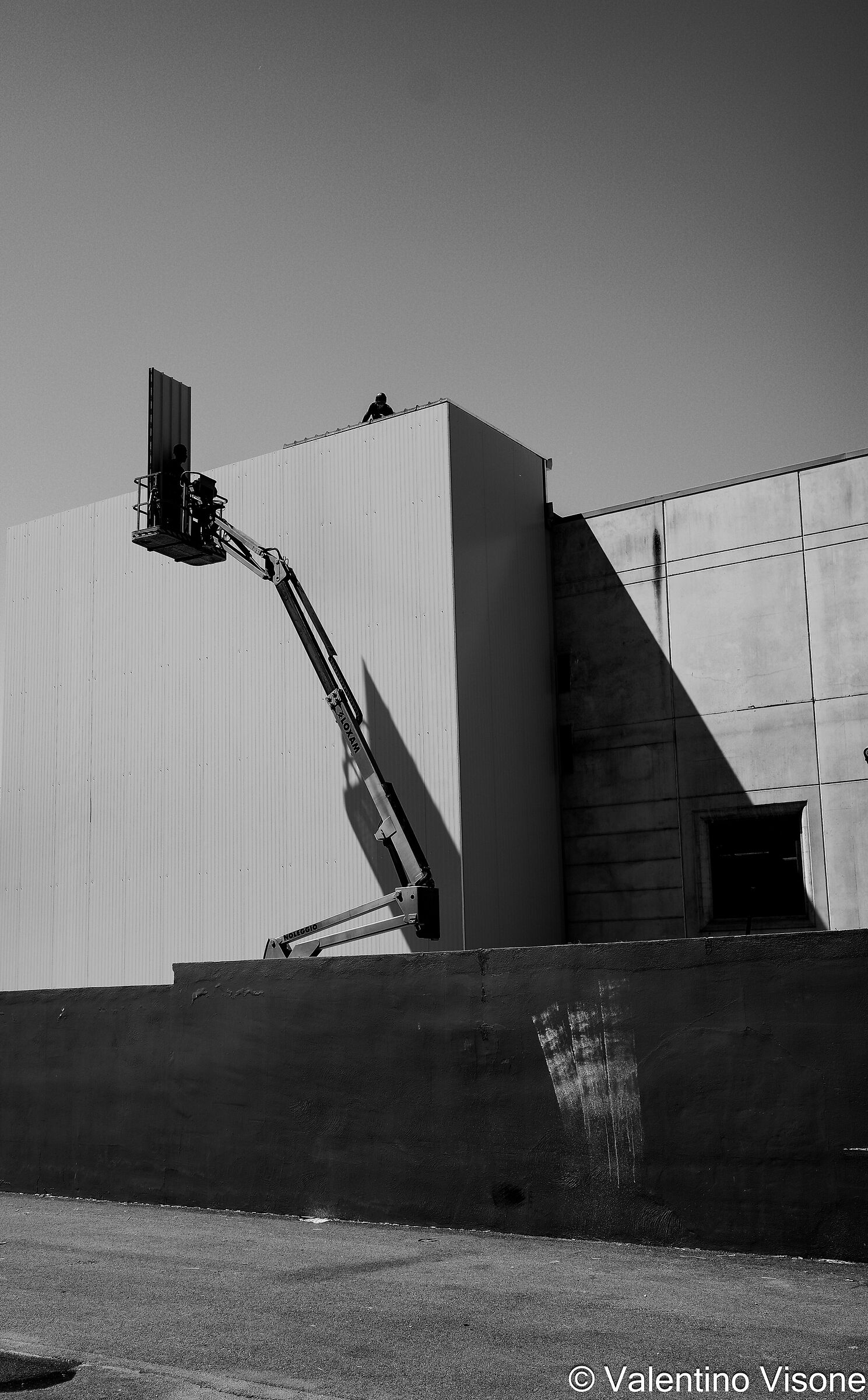 Construction workers on site. The giometry of shadows.