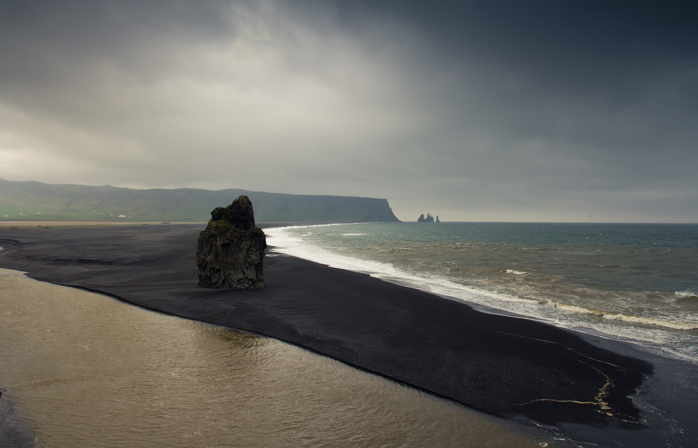 Dyrholaey: beach, black, dark sky, windy.