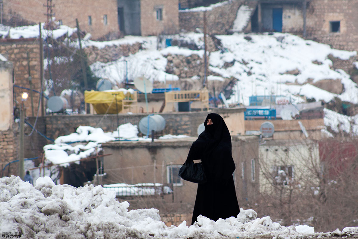 Woman waiting for the bus on the bridge of Hasankeyf.