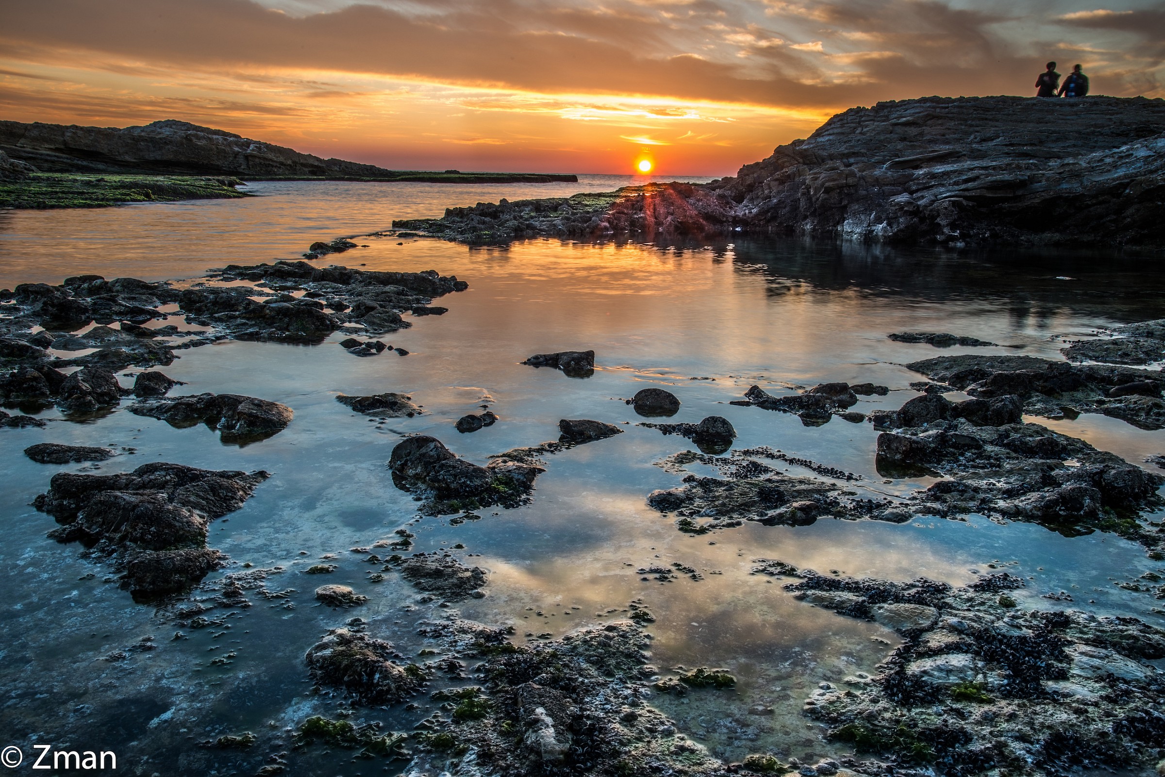 Couple watching Sunset Near Alrawshe Pigeon Rock