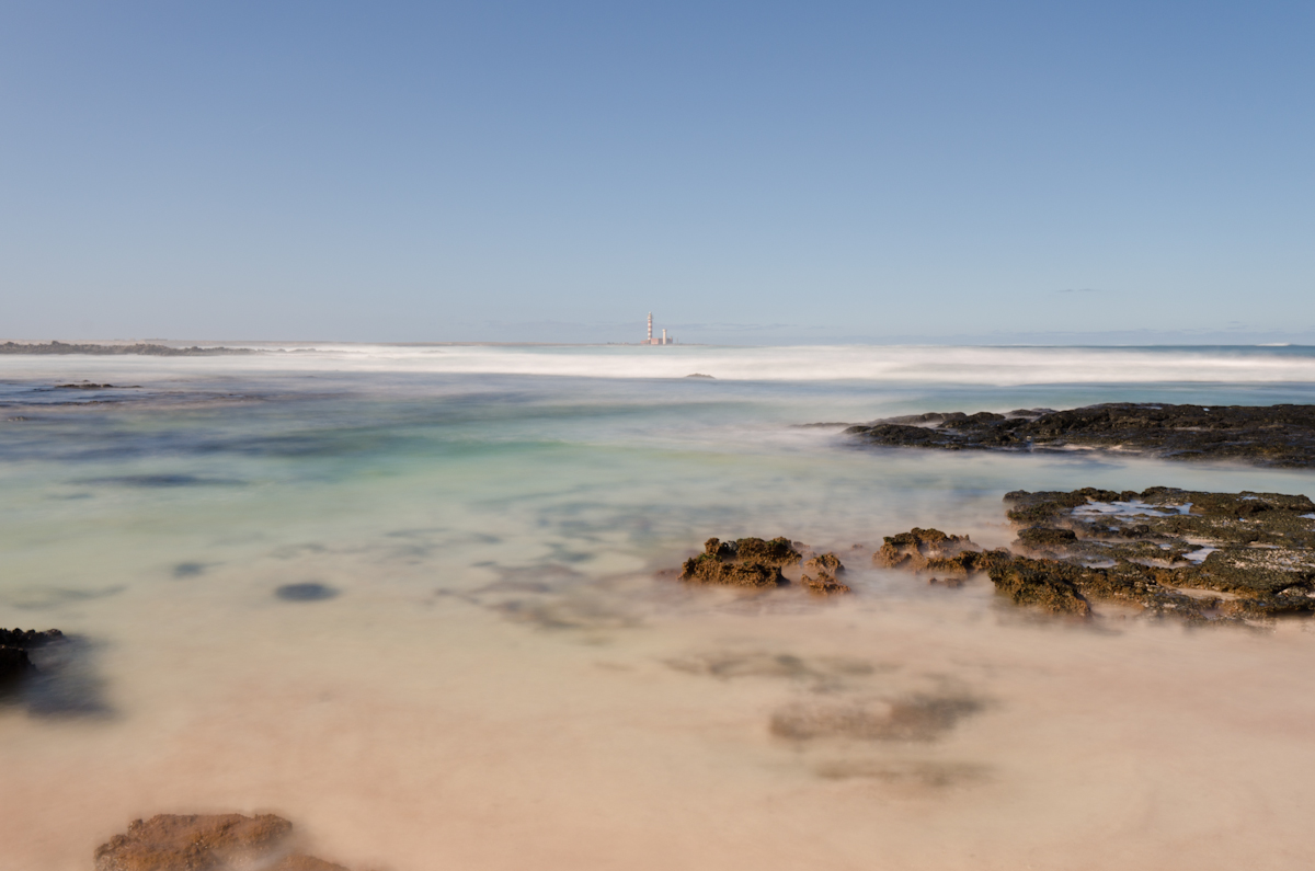 Playa Bubbles with the lighthouse of El Coston