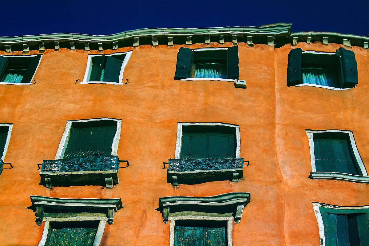 Buildings that are reflected in the lagoon of Venice