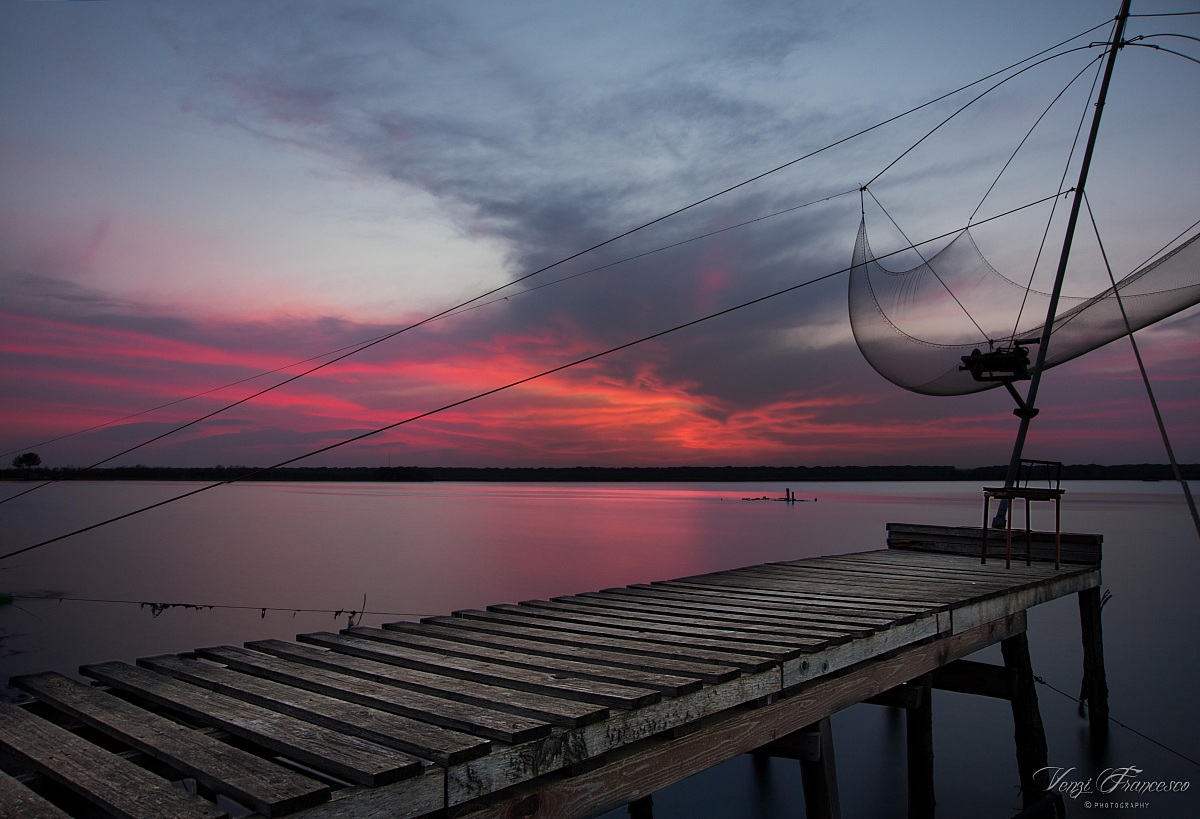 Shades of Pink on a pier thoughtful