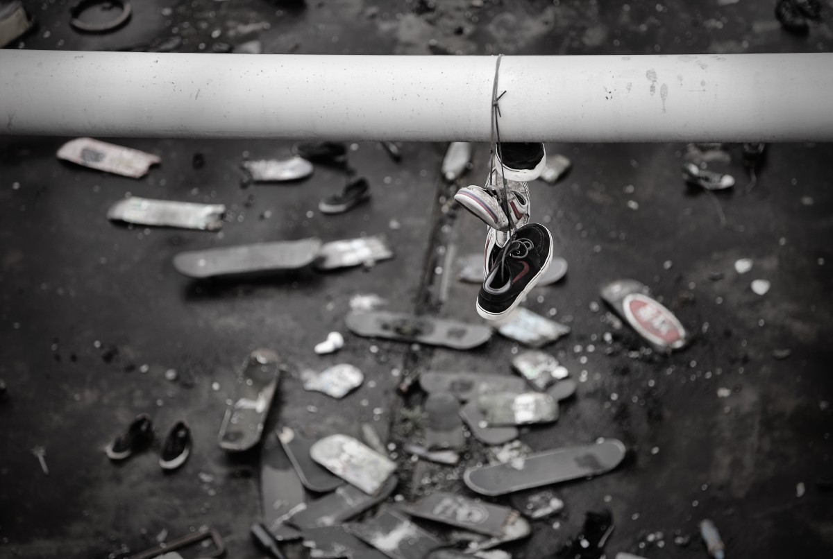 Lost shoes in skateboard graveyard of Hungerford Bridge