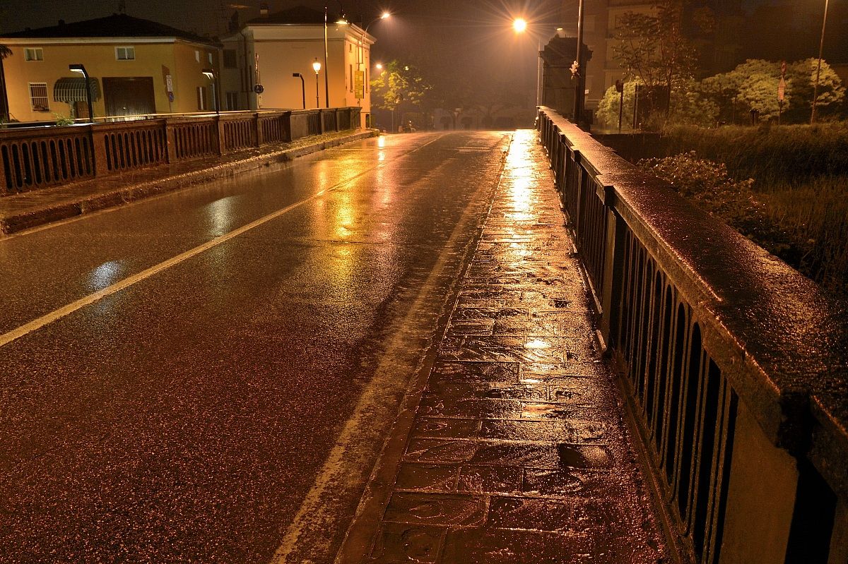 rainy night on the bridge by Colorno