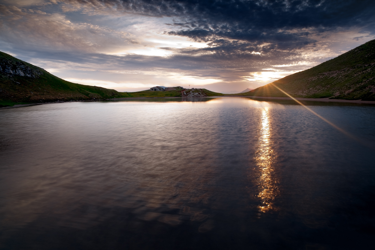 The gold of the sun glitters on the water