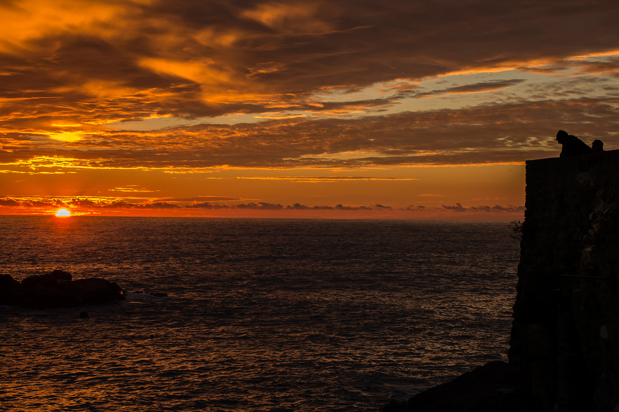 Admiring the sunset in Riomaggiore