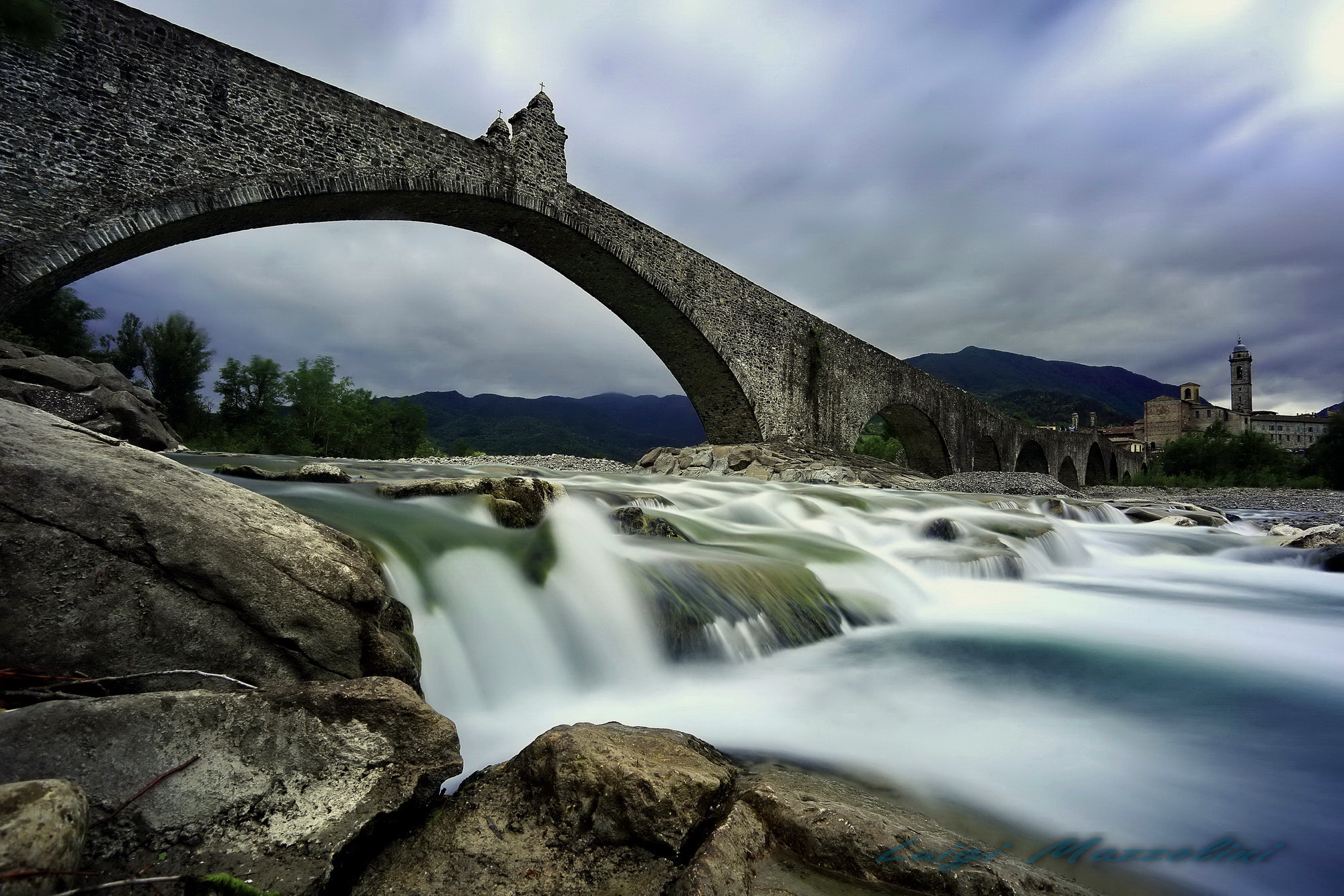 humpbacked bridge under the clouds