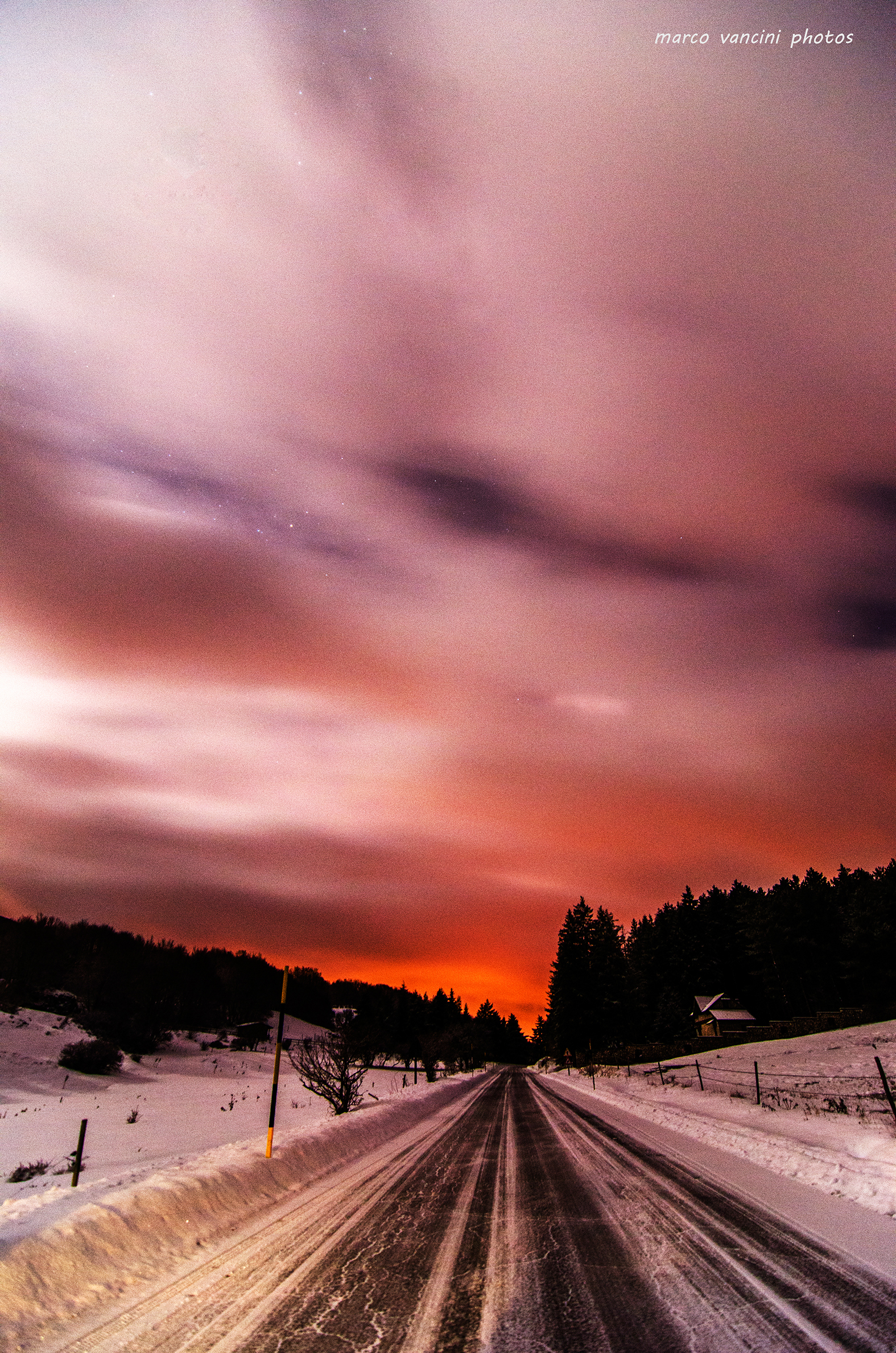 A red sky with clouds covering the stars
