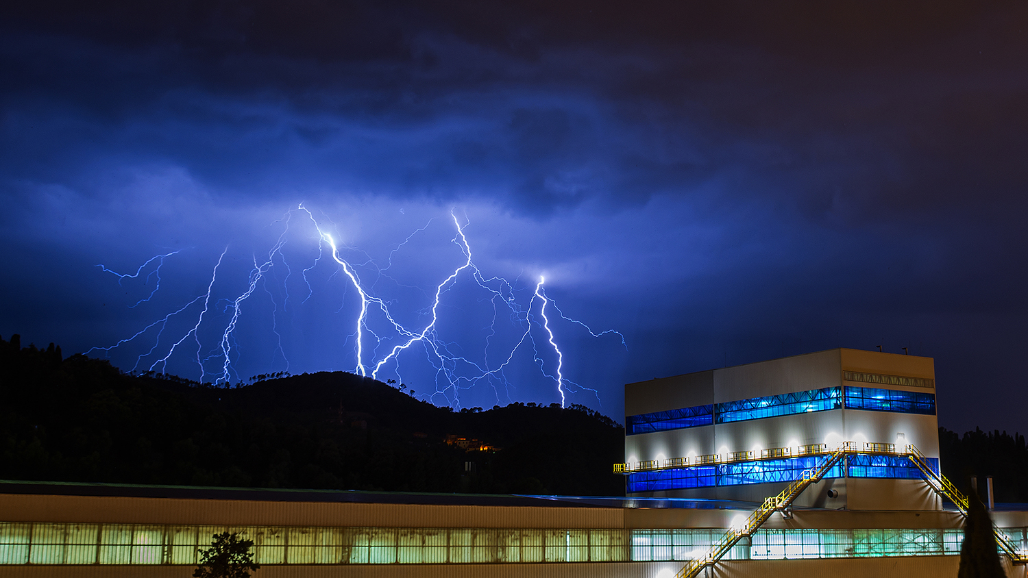 Lightning strikes behind the hill