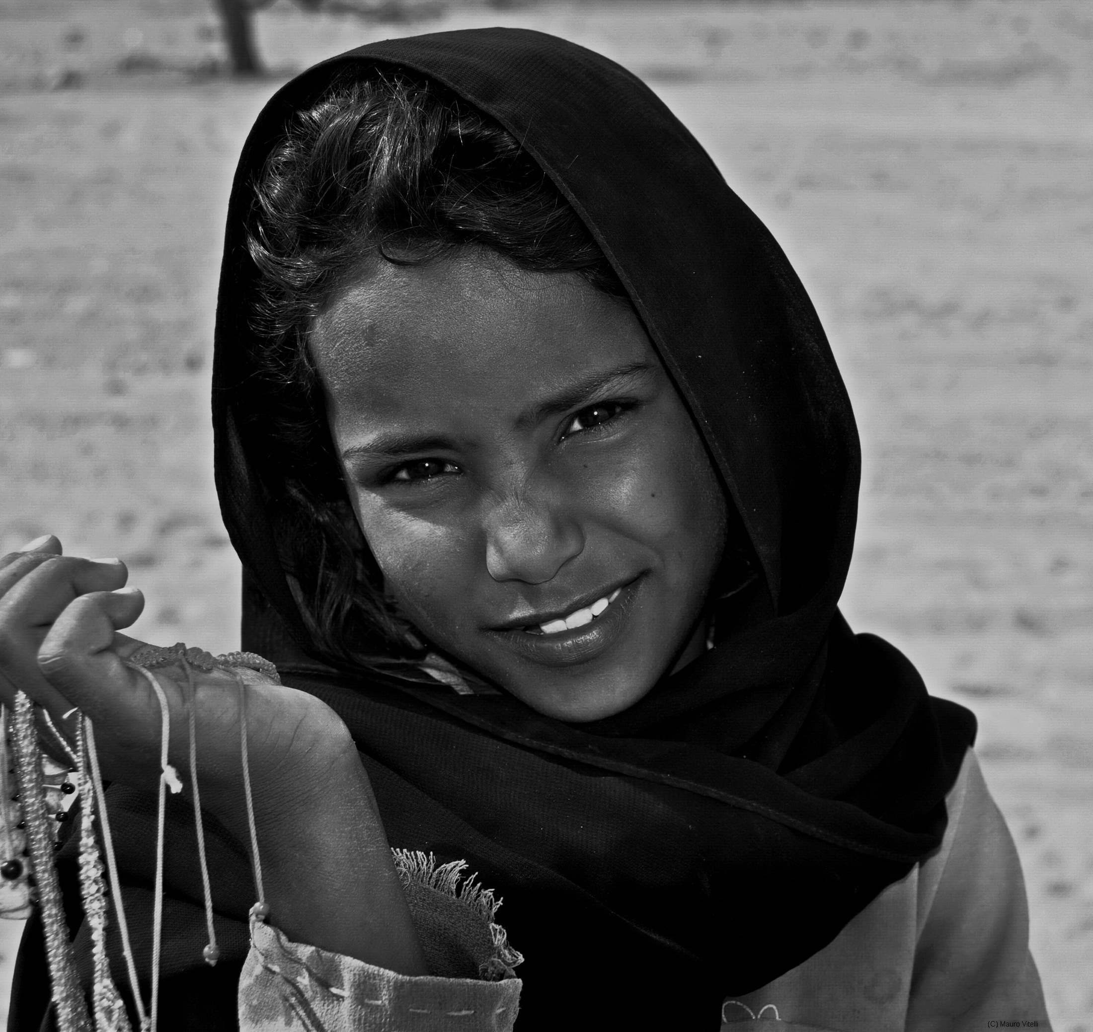 Small woman selling bracelets