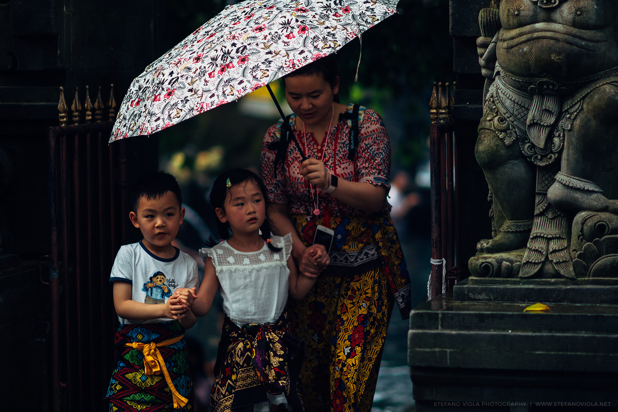 Mother and children at the sacred temple Tirta Empul