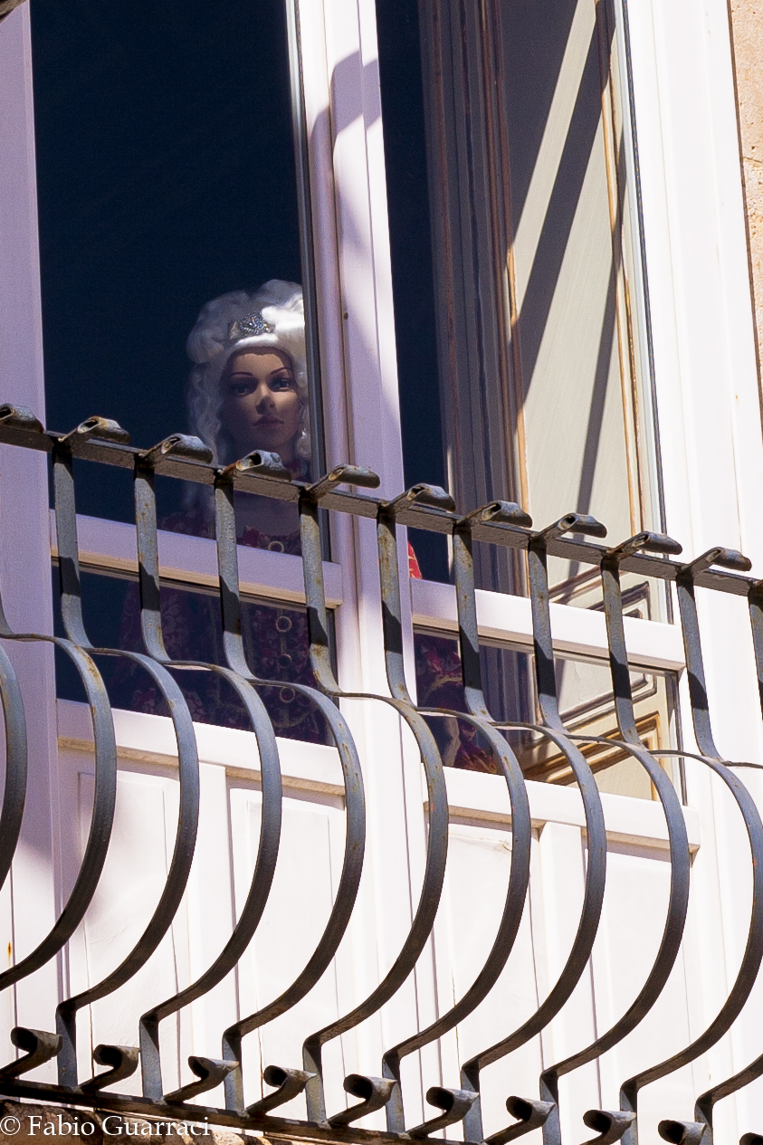 Piazza Duomo. Doll at the window.