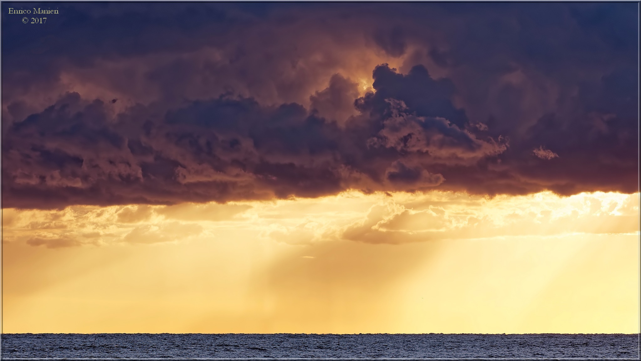 Nuvole nere sul mare all'alba