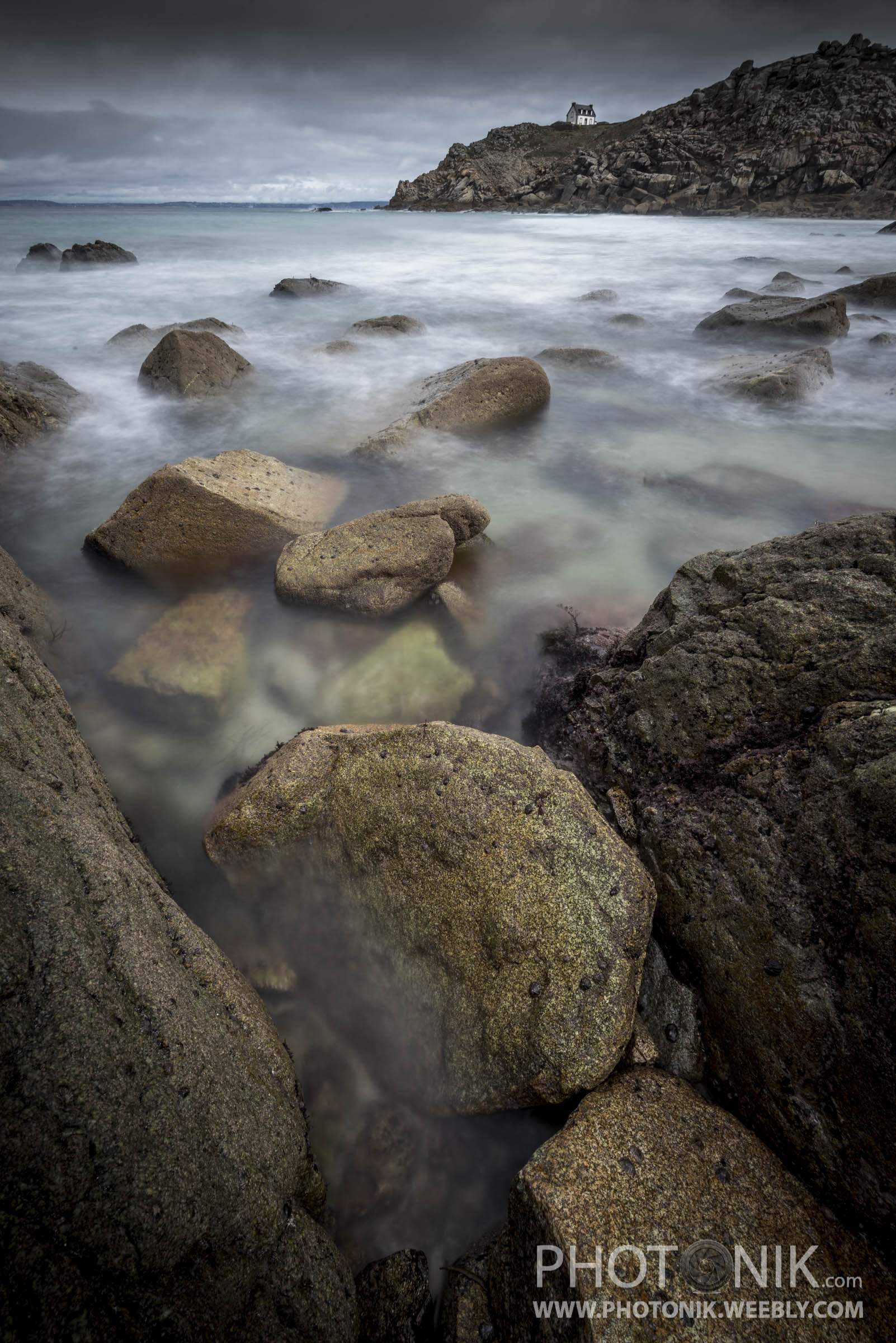 The lighthouse beyond rocks (Phare du Milier)