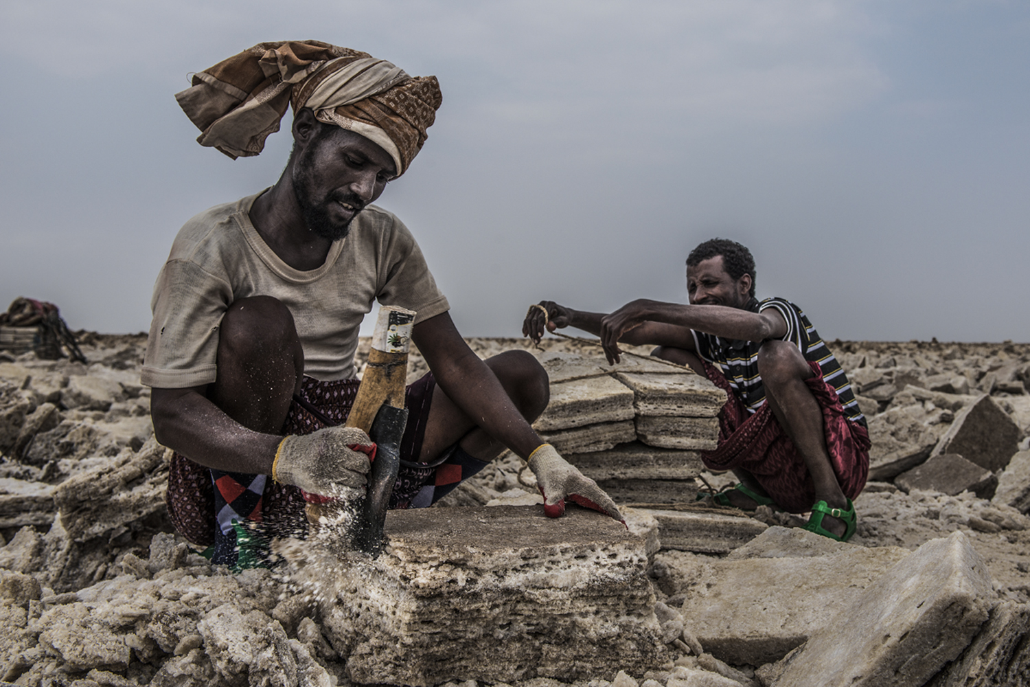 Afar man at work in the salt flat