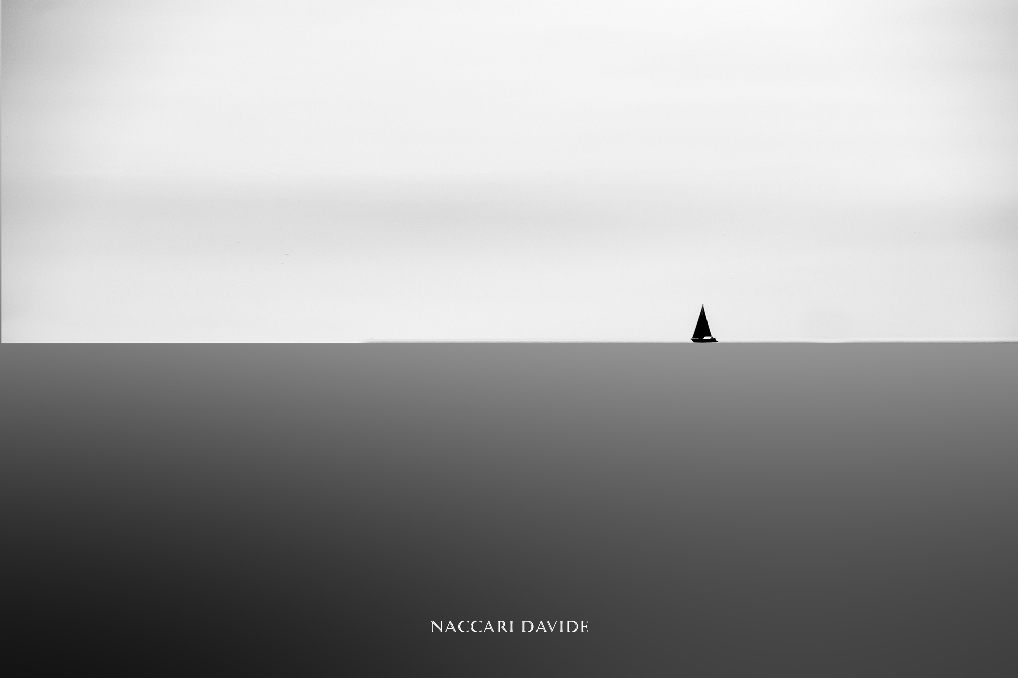 The small boat in the gray sea.