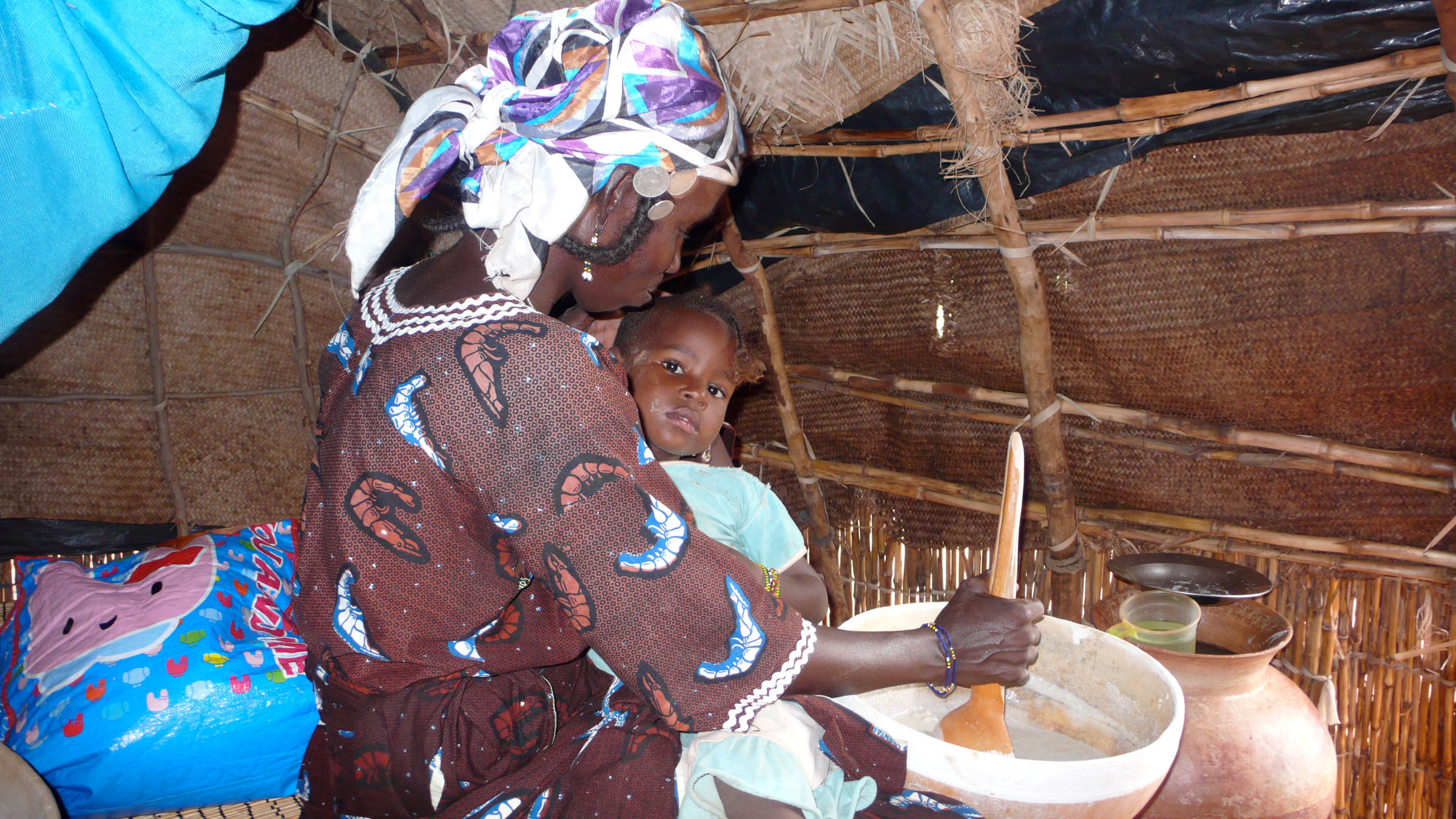 Mama Peuhl busy preparing the meal for her son