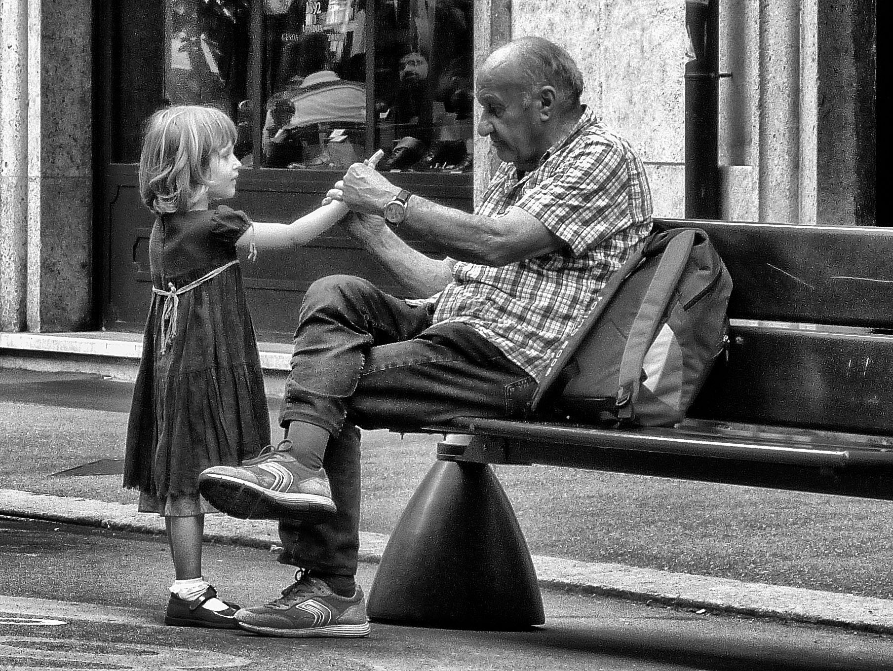 The old man and the child hold hands