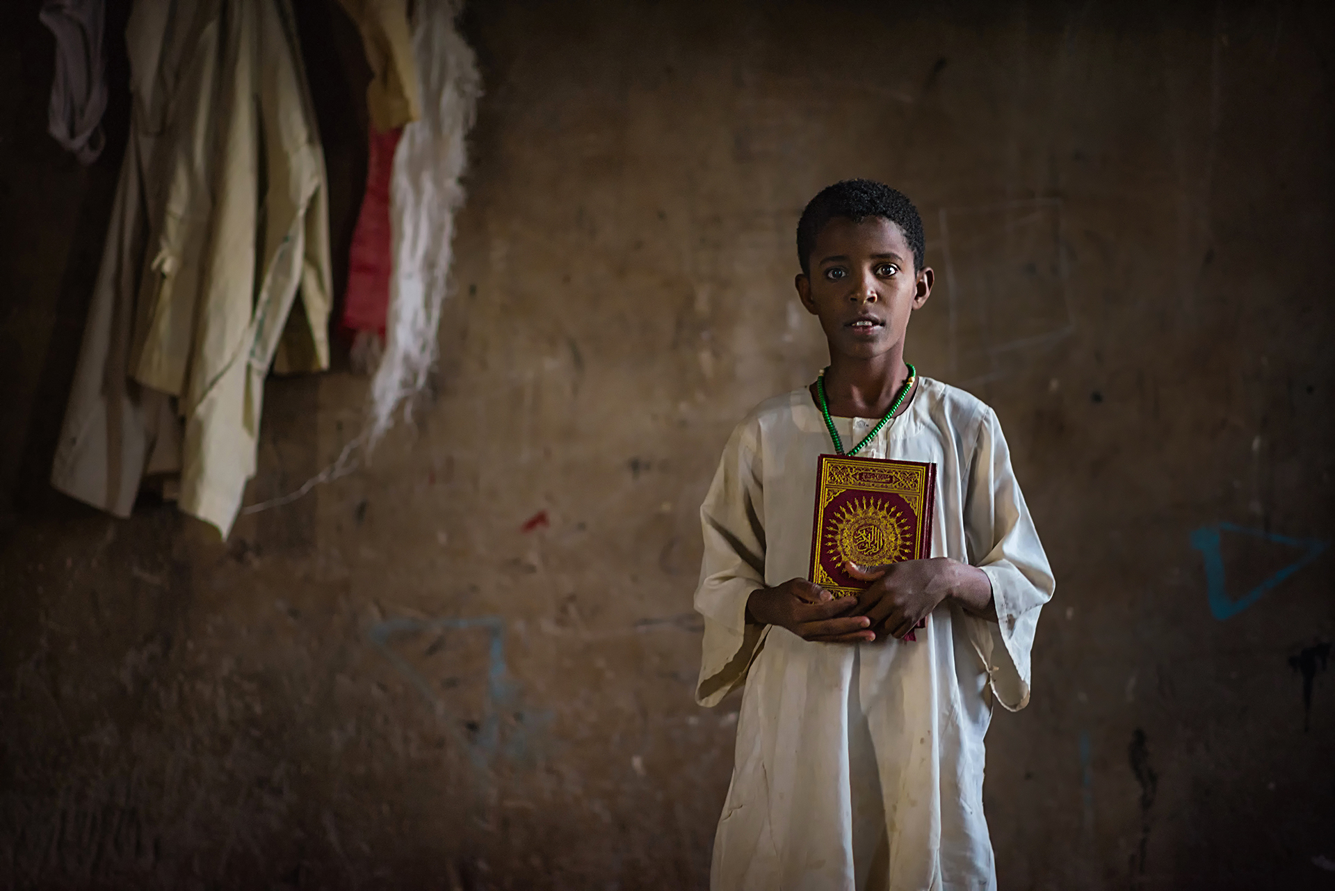 A boy Holding Qura'an