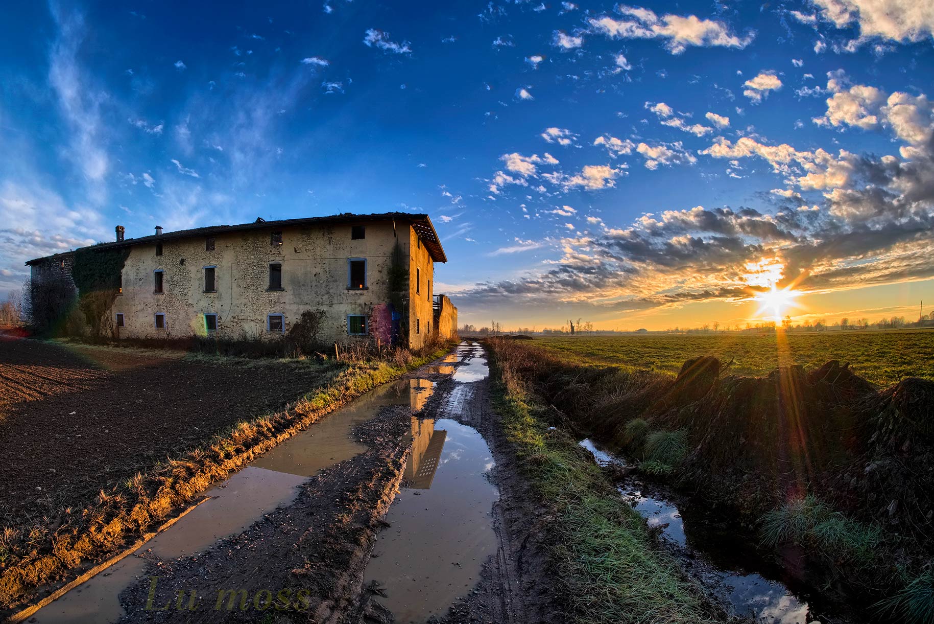 Tramonto, sulla cascina ormai a pezzi.
