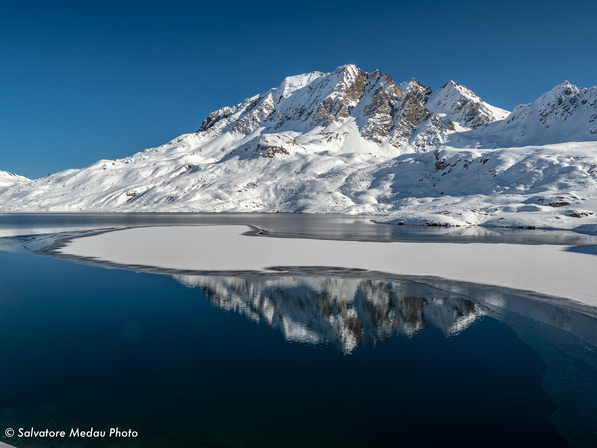 The tip of the term reflected in Lake Toggia.