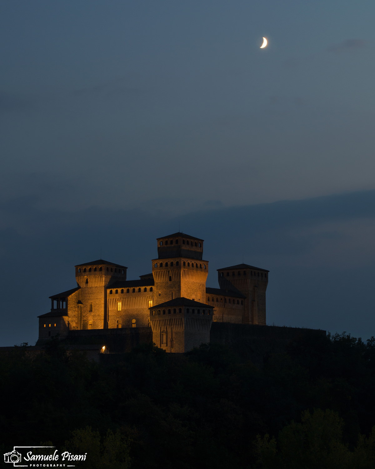 Night falls on the castle of Torrechiara