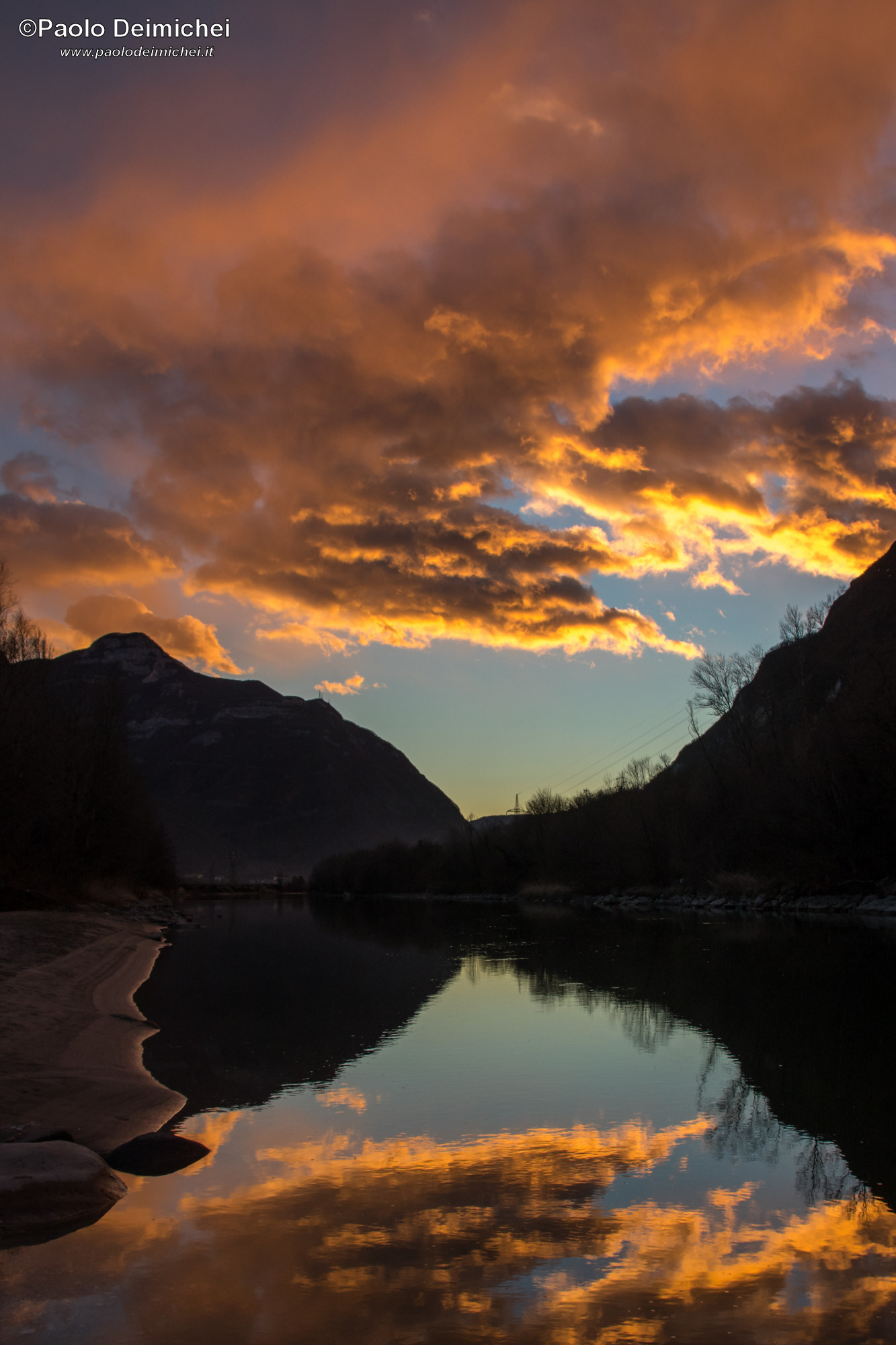 Fiery sunset on the Adige River