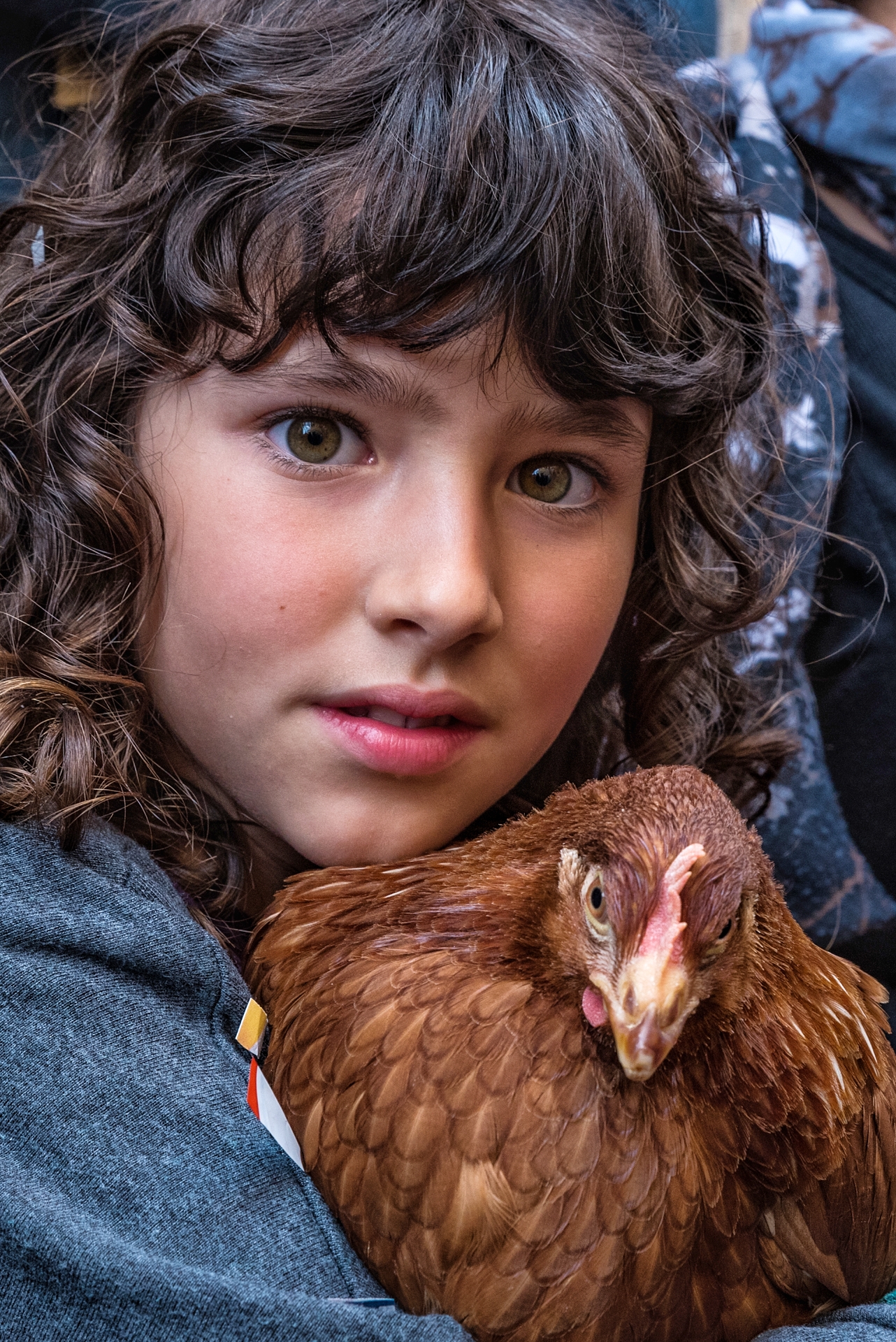 The little girl with the hen