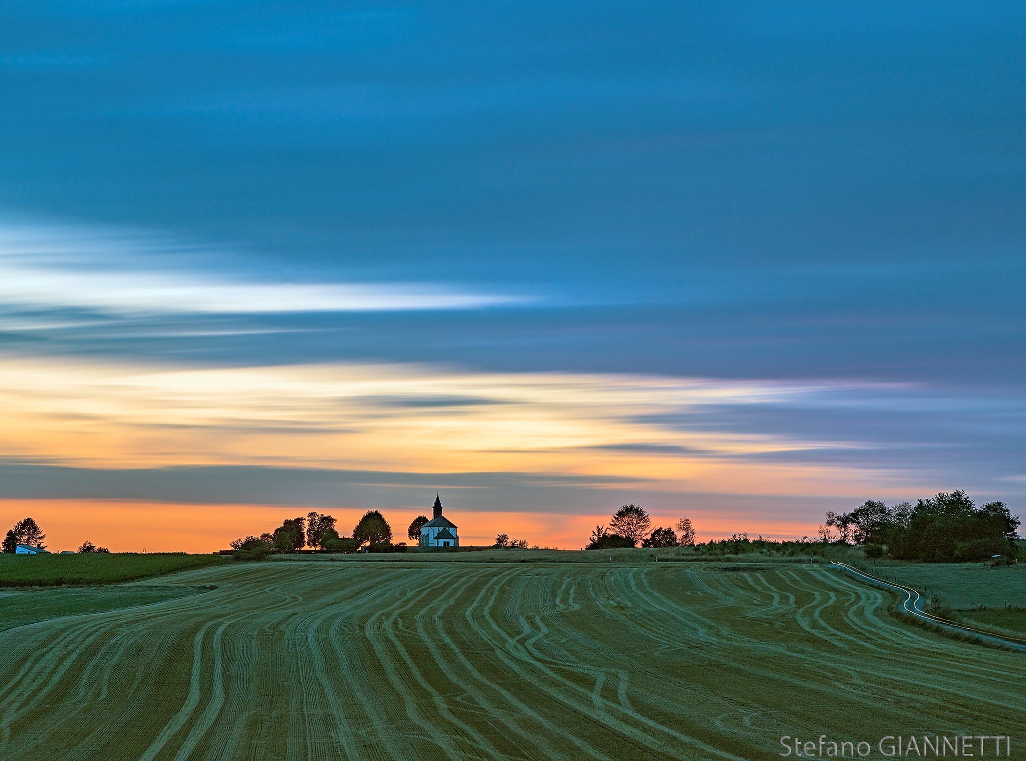 between the fields at sunset