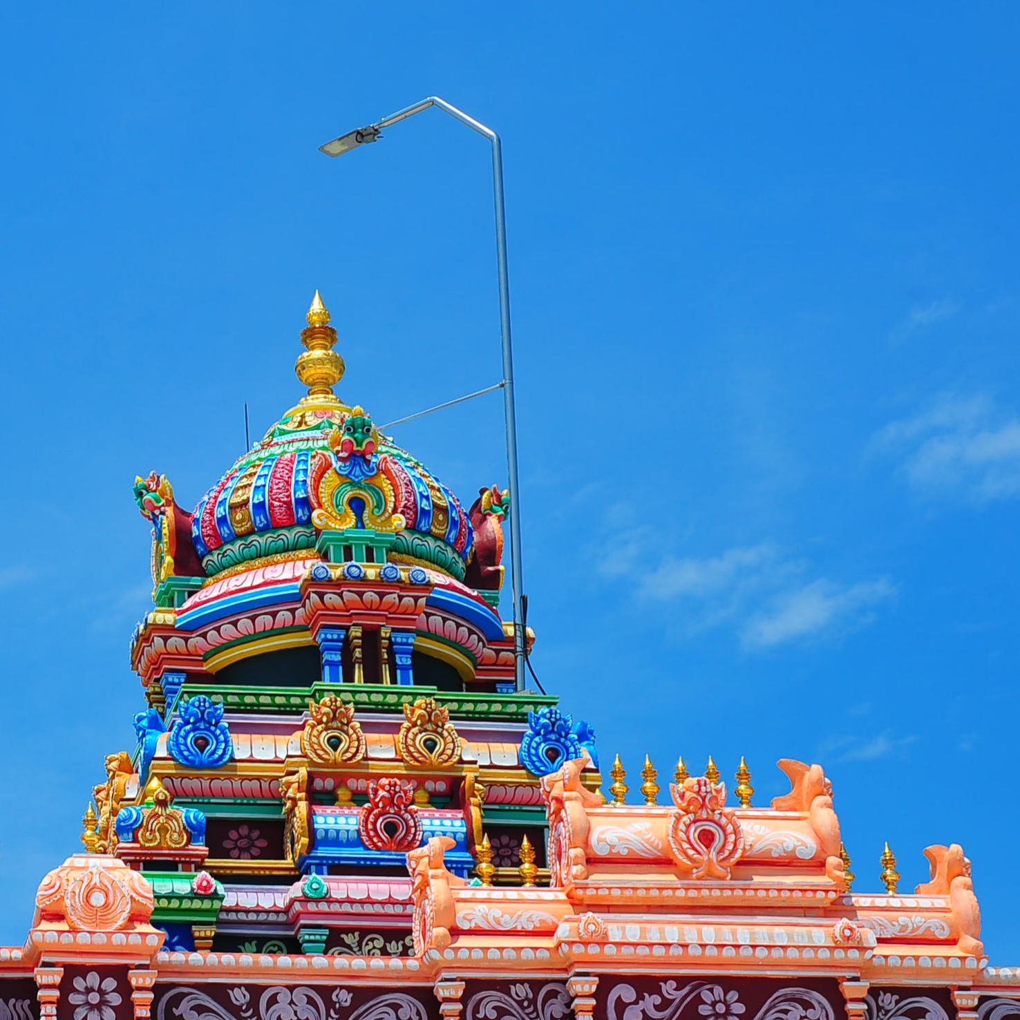 Hindu temple top against blue sky