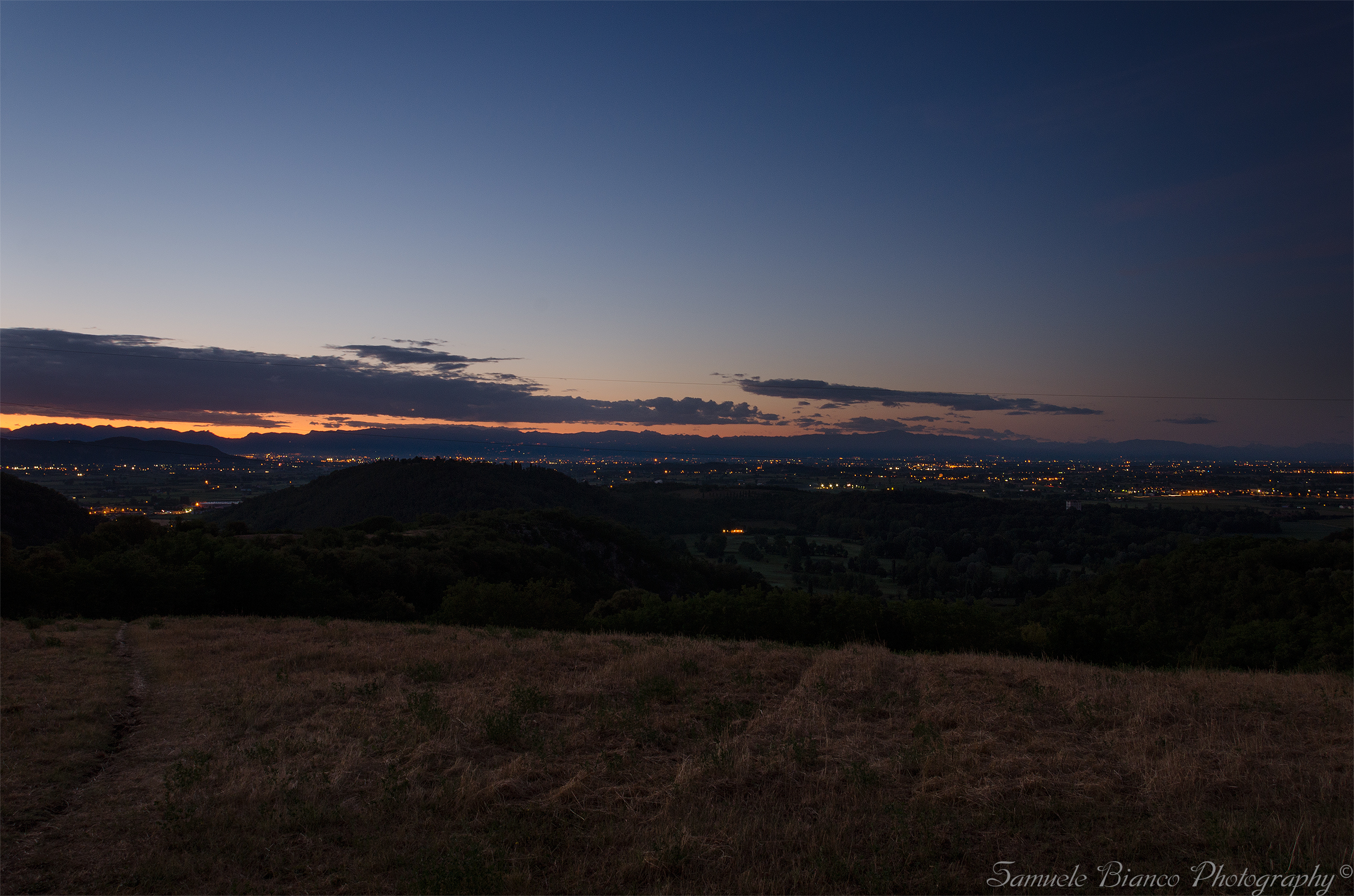 The sun rests behind the Alps