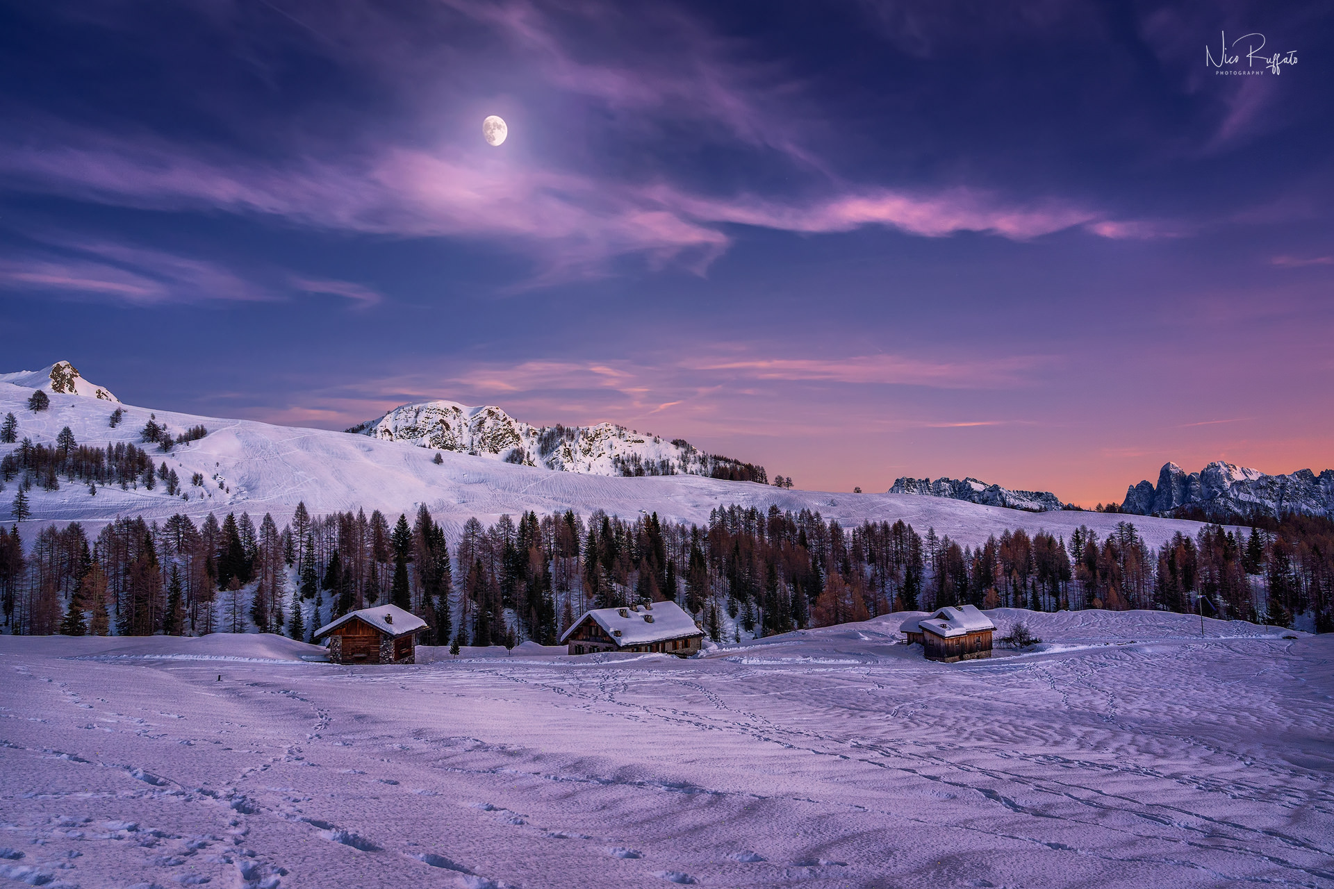 The moon emerges from the mountain