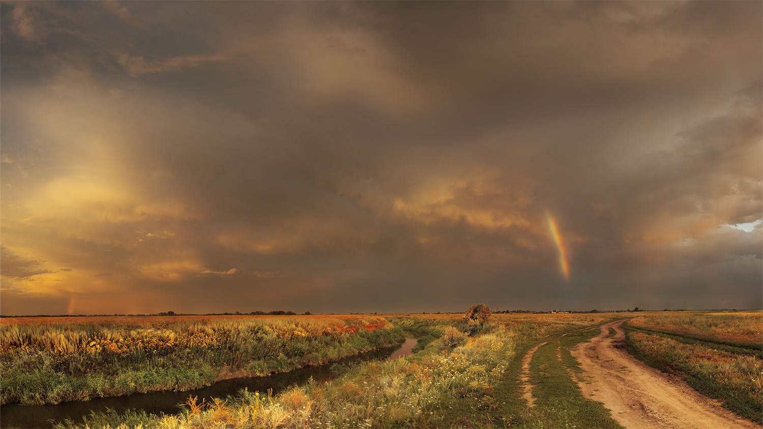 Fiume delle steppe dopo pioggia e arcobaleno