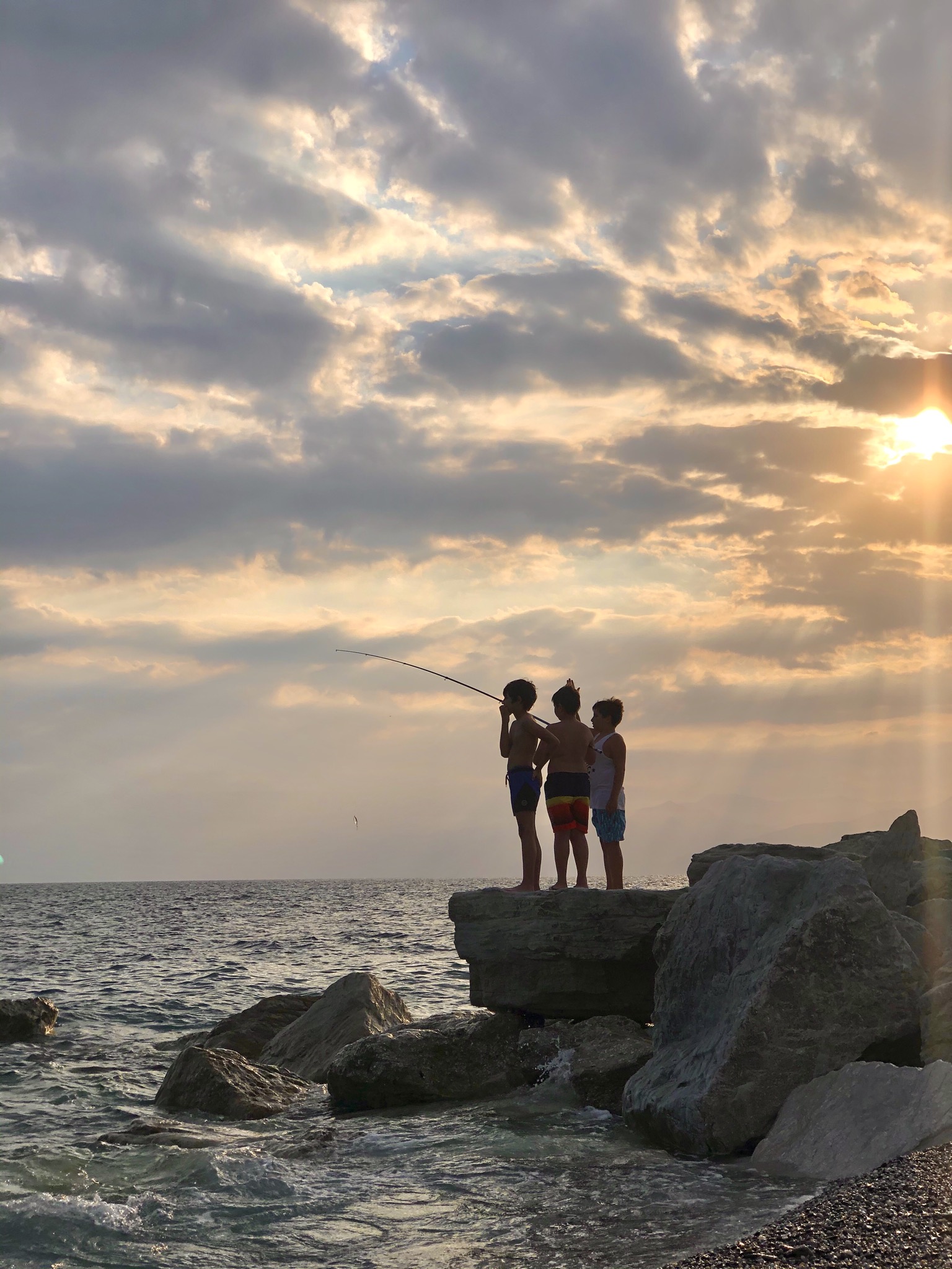 Boys fishermen at sunset